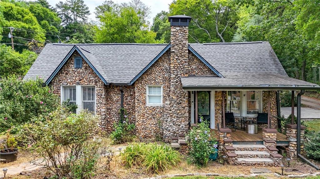 Brimming with character and charm, this 1920s rock exterior cottage offers just under 1,000 sq. ft. of thoughtfully designed living space. Step inside to find beautiful hardwood floors, a rock-face fireplace that serves as the heart of the living area, and an updated kitchen with stainless steel appliances that blend modern convenience with timeless appeal. The primary bedroom comfortably fits a king-sized bed, and the guest bedroom provides just the right amount of space for visitors, a home office, or a creative space. Outside, you’ll appreciate the detached garage for additional parking or storage, space for a garden, and a covered front porch and covered back patio — perfect for relaxing or entertaining once refreshed. With new exterior doors arriving August 20th and years of careful upkeep, this home pairs historic charm with modern touches in an easy-to-maintain size you’ll love coming home to.