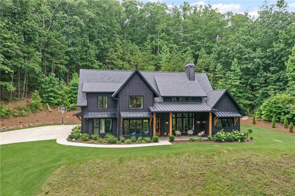 Welcome to this custom built 2020 Modern Farmhouse perfectly set on 2.73 private acres. The 4 bedrooms, 4.5-bathroom home features an open floor plan, spacious bonus room and beautiful hardwoods throughout. The light-filled family room showcases a soaring two-story ceiling. The chef's kitchen includes a walk-in pantry and an office nook with a custom-built in desk. Enjoy peaceful mornings and cozy nights on two covered porches overlooking a level backyard perfect for entertaining, kid fun or a future pool. The 3-car garage offers ample storage with one bay opening at both ends. Behind the backyard woods sits the elementary school-No future development. Style, space and privacy in a move-in-ready home.
