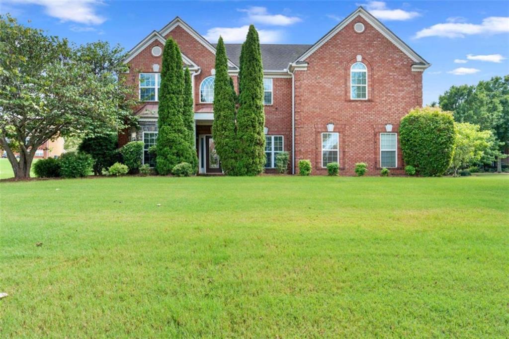 Welcome to this stately 4 bedroom, 2.5 bath home nestled behind the gates on a spacious corner lot in the prestigious gated community of Crystal Lakes. Known for its resort-style amenities, Crystal Lakes offers residents access to a premier golf course, clubhouse, swimming pool, tennis courts, a picturesque lake, playground, walking trails, and more-creating the perfect blend of luxury and lifestyle. This all-brick home is grand in both scale and style, featuring an attached two-car garage and a back patio ideal for outdoor gatherings. Step inside the soaring two-story foyer, flanked by a formal living room on one side and an elegant formal dining room with tray ceilings on the other. The heart of the home is the massive family room, complete with dramatic vaulted ceilings, abundant natural light, and a cozy fireplace. The kitchen is a dream-offering a walk-in pantry, center island, breakfast bar, breakfast area, and a keeping room that opens to the back patio, perfect for casual dining or entertaining. A convenient half bath completes the main level. Upstairs, all four bedrooms are generously sized and thoughtfully arranged for privacy. The oversized primary suite is a true retreat, featuring tray ceilings, double-door entry, and a luxurious en suite bath with dual vanities, a whirlpool tub, separate shower, and an expansive walk-in closet. The three secondary bedrooms share a well-appointed full bath and are ideal for family, guests, or flex use. A full laundry room with built-in cabinetry is also located on the upper level for added convenience. Don't miss this incredible opportunity to own a grand home behind the gates of one of Hampton's most sought-after communities!