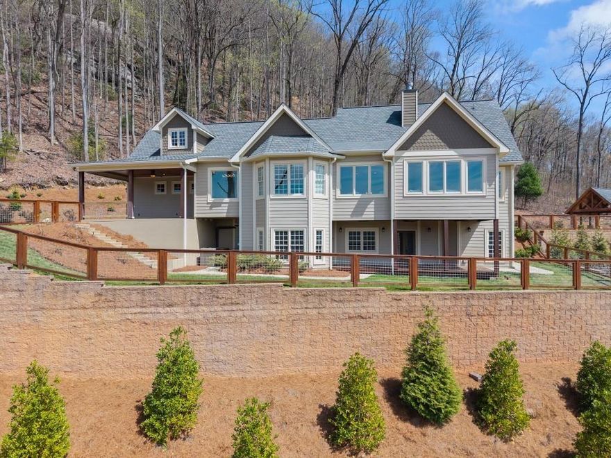 Nestled amidst the serene splendor of Tiger Mountain, this breathtaking 9-acre homestead seamlessly blends natural beauty with refined luxury. Located just 90 minutes from the heart of Atlanta and 12 minutes from the shores of Lake Burton and the charming town of Clayton, this property offers the perfect balance of accessibility and tranquil retreat. Perched high up the mountain the homestead boasts uninterrupted, panoramic views of pristine wilderness, facing expansive land managed by the US Forest Service-ensuring a timeless sanctuary with little chance of future development. Surrounded by towering hardwoods and the gentle whispers of nature this estate invites you to unwind and reconnect. The sprawling acreage provides endless possibilities whether you envision private hiking trials, a thriving garden, or simply a haven of peace and privacy. At the heart of this retreat lies an outdoor oasis designed for unforgettable gatherings: a heated pool with attached jacuzzi and cascading waterfall, a fully equipped outdoor kitchen, and a cozy fire pit area. All are crafted to elevate entertaining to a luxurious art form. Imagine hosting family and friends under the open sky, with ample space to invite then all- these amenities promise cherished memories filled with laughter, warmth and relaxation. The multilevel, Craftsman style, main house and accompanying pool house offer 8 spacious bedrooms, 8 full and 3 half bathrooms ensuring comfort and privacy for every guest. Enter the beautiful alder wood front door to discover rich hardwood floors that flow throughout. Ten-foot ceilings and eight-foot doors create an airy, expansive ambiance in every room. Adding to the allure are two stone fireplaces for those cool evenings. The owner's suite elevates luxury further with a spa-inspired bathroom featuring marble tile and a beautiful soaking tub room with a view overlooking the mountains. Convenience meets indulgence with two full kitchens, two additional kitchenettes, four laundry areas and a rejuvenating indoor sauna.  Every detail has been thoughtfully designed to make life effortlessly enjoyable whether you're preparing a feast, unwinding after a day of mountain or nearby lake adventures or simply soaking in the serenity. From the crisp mountain air to the star-filled skies, this Tiger Mountain gem promises a lifestyle defined by natural wonder, boundless possibilities and the ultimate in sophisticated comfort. Imagine the memories waiting to be made in a place where luxury and nature unite in perfect harmony.