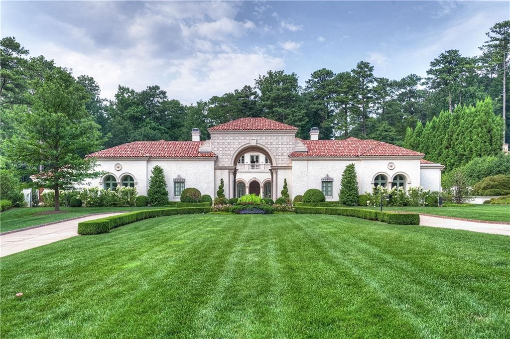 This extraordinary Mediterranean style masterpiece located in premier Tuxedo Park neighborhood is the jewel you've been waiting for. Built by master Atlanta builder Jon Berndsen, this spacious, light-filled home effortlessly blends functionality with elegant and vibrant interiors. You'll marvel at the thorough attention to detail from the stone and wood floors below to the 12' ceilings above. Three impeccably crafted levels provide privacy and comfort, including three secondary suites plus two guest suites. Primary bedroom on the main level features dual offices, closets, and baths. This home features all the specialty amenities including wine cellar, media room, bar, gym, generous storage, ample guest parking and more. Enjoy the formal gardens complete with a heated pool and limestone patio, with plenty of room for additional outdoor family recreation. This unique home doubles as an entertainer's dream, as well as a private family haven.