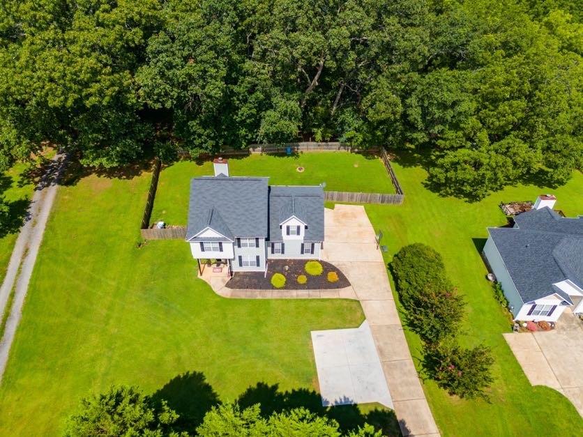S p a c i o u s, Well Kept, and a great Location! Welcome to this easy-to-maintain two-story home featuring vinyl siding and no carpet on the main level. Enjoy a formal dining room, a cozy den with a wood-burning fireplace, and a bright kitchen with a bar, breakfast area, and a separate laundry/mudroom for added convenience. The backyard is level and partially fenced for privacy (including a double gate perfect for putting a truck, trailer, etc. back there), with a brand-new back deck perfect for relaxing or entertaining. The large master suite features tray ceilings, a walk-in closet, double vanities, and a separate jacuzzi tub and shower. Additional highlights include: * Crown molding throughout * Updated HVAC and roof * Fully updated guest bath with tiled floors and a shower * All appliances included * Flat, fenced-in backyard *Attached enclosed garage. Location is everything, and this home offers it all! Just 10 minutes to I-20, under 5 minutes to downtown Carrollton and Adamson Square (featuring outstanding restaurants, shopping, the AMP, Lake Carroll), and only 3 minutes to the Hobbs Farm Greenbelt trailhead, Ingles, and local restaurants. This home offers hard-to-find square footage at this price point in a highly sought-after location. Don't miss your chance to make it yours!