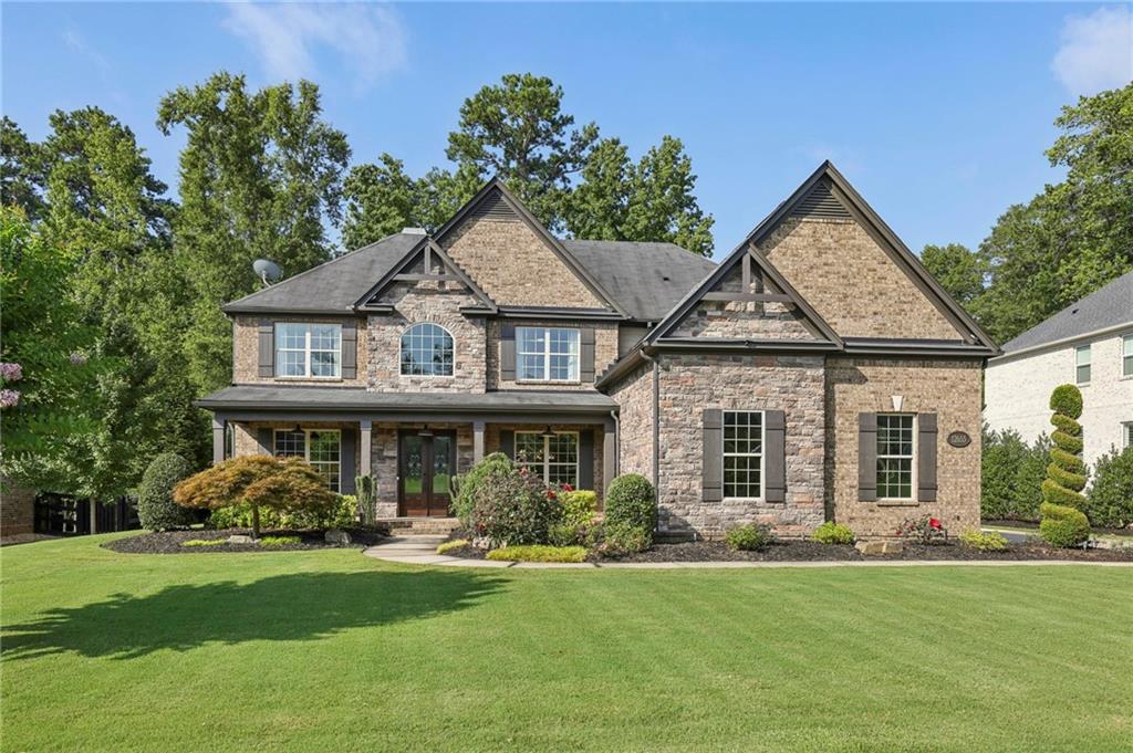 Move-In Ready and Ready for Quick Close– Ask About Our Lender Who Can Close in Just 3 Weeks!
Beautifully maintained and packed with upgrades, this 4-sided brick and stone traditional home is located in a quiet cul-de-sac in an active swim/tennis community just minutes from Downtown Alpharetta, Avalon, and Crabapple Market—with quick access to GA-400 for commuters.
Step inside to find a light-filled, neutral palette and a spacious layout with formal living and dining rooms, a guest suite on the main, and a stunning two-story great room featuring a wall of windows, floor to ceiling stacked stone fireplace, built-in bookcases, and coffered trey ceiling.
The gourmet kitchen is a chef’s dream—complete with stainless steel appliances, granite countertops, an island, and a breakfast area that opens to the keeping room and great room.
Upstairs, you’ll find the oversized primary suite with a massive walk-in closet and spa-like bath, plus three additional bedrooms, a jack and jill bathroom and a private en-suite and a convenient laundry room.
Outside, the flat, beautifully landscaped backyard is ideal for entertaining, with a covered patio featuring a fireplace and TV, a pergola, and plenty of privacy. The large, flat driveway leads to a generous 3-car garage with built-in storage that stays. Enjoy relaxing on the charming front porch with a swing for the new owners and space for rocking chairs.
This home has been meticulously cared for by an owner who is immaculate and detail oriented. This home is truly move-in ready. Don’t miss your opportunity—schedule a showing today and close in just 3 weeks!