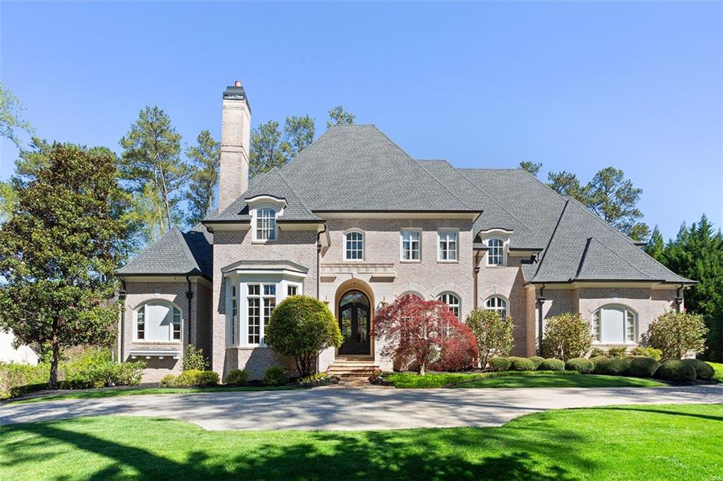 Sumptuous designer renovation of this gated estate home with every possible upgrade including a sparkling pool and multi sport court! The light filled entry is punctuated by a spiral staircase that frames the open concept floor plan and is capped by a dome ceiling. The formal living & dining rooms off the entry are complimented by a paneled study, one of two on the main level. The chef's kitchen with an enormous quartzite island and stainless commercial appliances is open to the family room with a beamed vaulted ceiling and warmed by a masonry fireplace, one of four in the home.  The primary suite on the main level boasts an indulgent spa bath swathed in marble with his & her closets, dual vanities and a walk in shower.  The primary suite on main offers direct access out to the loggia overlooking the sparkling pool. Two staircases provide access to upper level with four ensuite bedrooms showcasing designer baths. The terrace level is an entertainers dream with a full bar, home theater, billiard area and a den space, along with a full guest suite, an office and direct access to the side yard with the multi sport court. The Crestron smart house system controls the audio and lighting system with endless customizable options.  12' ceilings on main, three powder rooms, two laundry rooms, a generator and the list goes on. Surrounded by manicured grounds and ensconced behind the brick walls and fenced in rear yard, this luxurious  estate provides supreme privacy and exclusivity.
