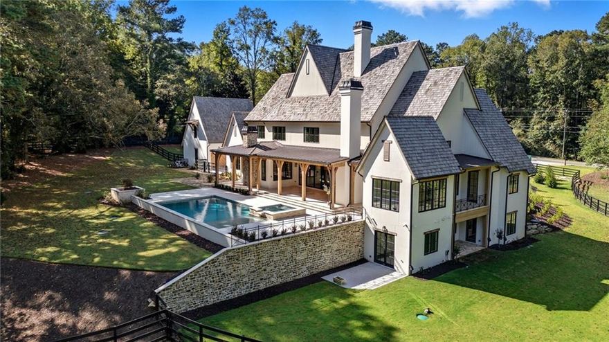 Beautiful Custom Home on gorgeous estate lot in exclusive Milton. This amazing  European Provencal cement stucco and stone home combines all the Traditional luxuries with Modern style. This estate home is situated on a private 4.48 acre lot. The Open Concept floor plan has a custom modern Staircase visible from the front through the dramatic black framed two story window. Upon entering the Iron Framed double doors the two story Family room opens to the beautiful backyard. As you walk out the main level into The backyard Oasis, complete with expansive Travertine patio you look out to the beautiful pool, and spa facing the private woods with a creek in the distance. Pool bathroom is just one of the details this home includes. The Chef's kitchen has a dramatic marble island which opens to the Family Room and Keeping Room. Kitchen Boasts a 60" Wolfe Duel Fuel Range, Two Miele Dishwashers, Sub Zero Refrigerator and Separate Freezer, Large pantry, Butlers pantry, and Mud Room. This home has Two Laundry Rooms. The main floor includes an Owner's Suite with separate sitting room, which has private balcony. Large bathroom, which also opens to balcony, and amazing His and Hers closets. The Guest En Suite, also on main, has its own door leading to the back guest terrace over looking small fountain. There are 3 additional bedrooms upstairs with private baths and an oversized bonus room. The finished Terrace level includes an Office, Exercise Room, Steam Shower, Cold Plunge Room, Bar, Theatre Room, and tons of storage! This is an amazing Home for Entertaining. 2 Car garage and an additional separate 2 Car Garage with option of future teen or in-law suite above. Amazing Milton location! Minutes from Down Town Alpharetta and Avalon! Great Schools! Professional photos coming soon!