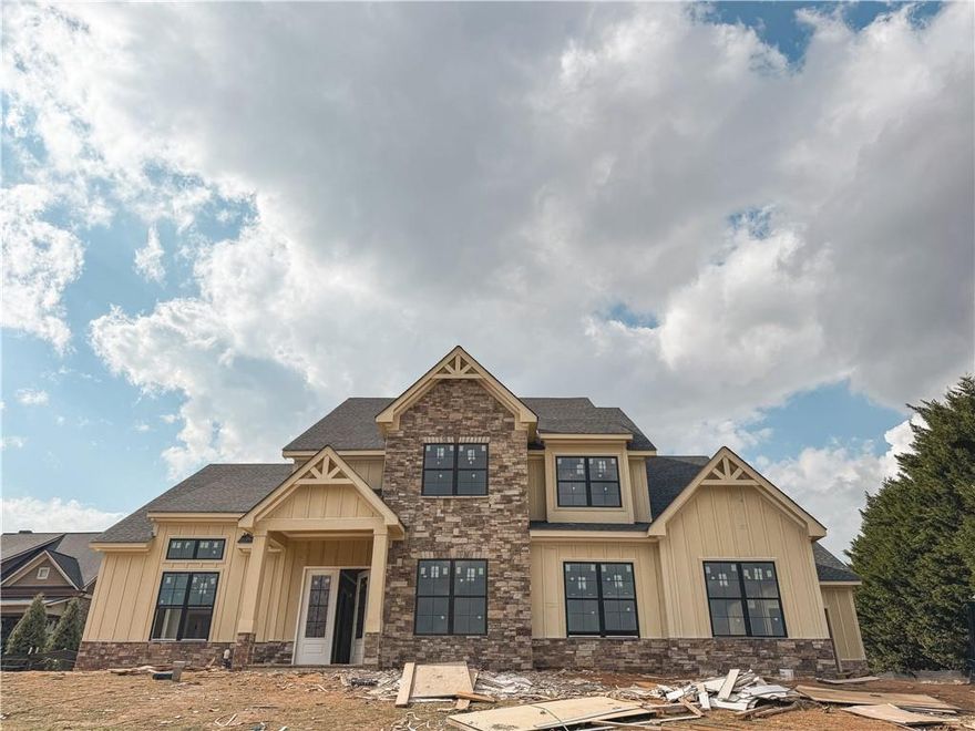 Stunning New Construction Home with Golf Course Views! Experience luxury living in this beautifully designed 4-bedroom, 3.5-bath home situated on nearly ¾ of an acre, just minutes from downtown Dawsonville. Step inside to discover an open-concept floor plan featuring soaring ceilings in the living room and seamless flow between the kitchen, dining, and gathering areas—perfect for entertaining. The oversized master suite provides a peaceful retreat with plenty of space to relax and unwind. Enjoy outdoor living at its finest on the large covered patio overlooking the lush golf course views. With its spacious layout, premium location, and modern design, this home combines elegance, comfort, and convenience in one exceptional package. Don’t miss your chance to own this incredible home in one of Dawsonville’s most desirable settings! ESTIMATED COMPLETION DATE: DECEMBER 2025.