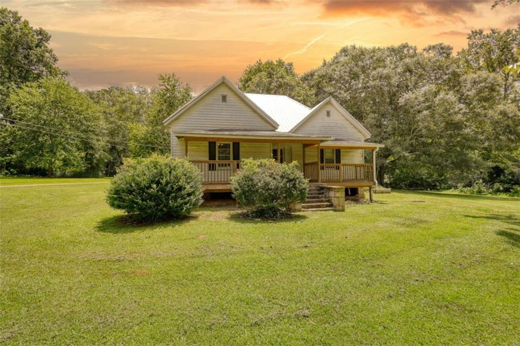 Step back in time with this charming circa 1935 farmhouse, perfectly situated on over one acre of picturesque land brimming with mature trees and a pond view. This 3-bedroom, 2-bathroom home features some of the original hardwood floors and decorative-only original fireplaces. The interior has been thoughtfully updated to enhance comfort and efficiency with a spacious eat-in kitchen and all the modern conveniences. While some exterior repairs are needed, the home maintains its classic farmhouse character and offers endless possibilities. Whether you're relaxing on the front porch, gardening in the backyard, or enjoying the peaceful pond view, this property offers plenty of space to roam and unwind. RARE BONUS OPPORTUNITY: the adjacent property on the same shared driveway is also listed for sale offering the chance for multigenerational living and homesteading! Don't wait - schedule your tour today to experience the best of rural living with all the modern comforts!