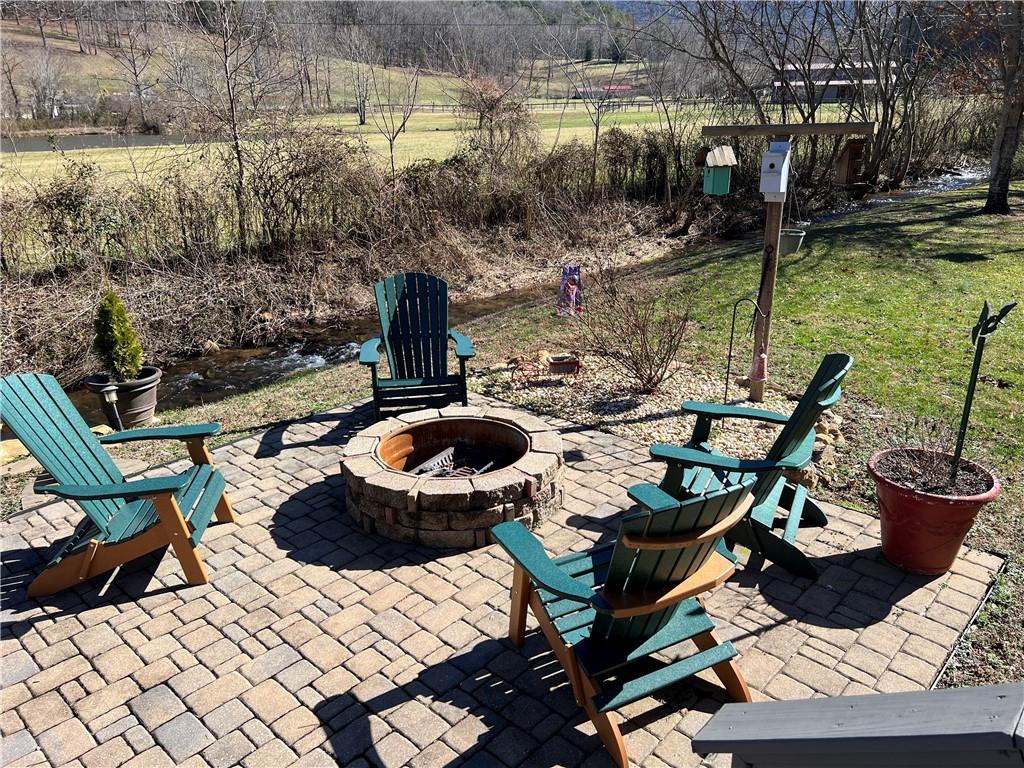 Reduced!! Getaway to this oversize private lot at the end of the road with mountain views and a running creek right outside your steps! Level lot for play or relaxation with deck, firepit, large storage building, and so much more. Fully furnished RV is ready with king bed, large open plan with kitchen/living room, fireplace, pantry and more! Could be part time or full time! One of the largest lots in the neighborhood with the most privacy! Come relax around the fire with friends and let all your cares melt away!