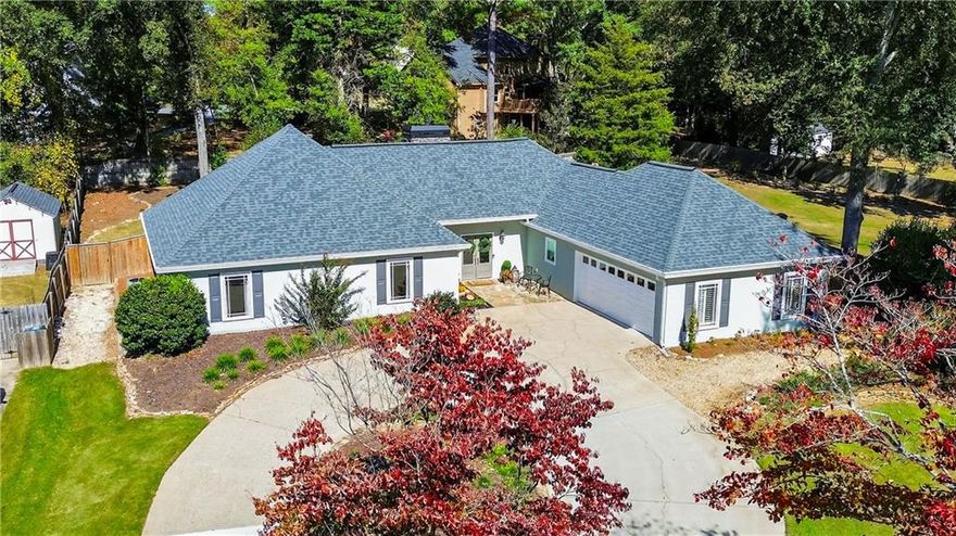 This perfectly sized ranch just keeps getting better and now at a new price! Fully renovated inside and out, this property offers modern luxury with timeless comfort. Located just minutes from Downtown Alpharetta, Avalon, and GA-400, convenience is unmatched, and the home is zoned to top-rated schools. The floor plan combines distinct living, dining, and kitchen spaces that flow seamlessly together. The vaulted family room with a stone fireplace creates a warm gathering spot. The designer kitchen features quartz countertops, full-overlay cabinetry, ceiling-height backsplash, stylish lighting, and a walk-in pantry with wood shelving. New LVP flooring throughout adds a fresh, updated look. The primary suite impresses with a spa-like bath: quartz vanity, walk-in frameless shower, and custom tile. Two additional bedrooms share a beautifully renovated jack-and-jill bath. Recently completed improvements include a new front door, hardcoat stucco, double-pane windows, tankless water heater, and expanded electrical panel. The large, level, fenced backyard is gorgeous and landscaped with sun-filled grass and hardwoods—ideal for a pool, screened porch, or outdoor kitchen. New storage shed included. Andover North offers a community pool and playground. A perfect blend of location, updates, and lifestyle awaits on Dover Ave!