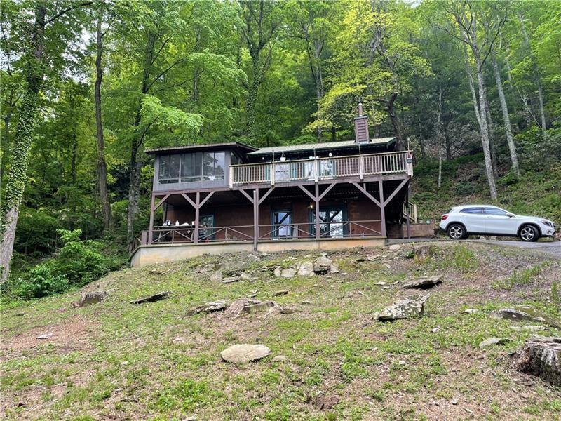 Experience the best of both worlds: Mountain life and City life!!!! This 3 bedroom 2 bathroom home is located in the middle of Clayton Ga and is close to Heavens Landing. Enjoy spectacular mountain top views reaching to the Carolinas. This home is nestled in the highly sought after Screamer Mountain and just moments away from shopping and dining. You will be in an excellent school system and only 10 minutes away from the school where elementary, middle and highschool all share a campus. The home has a brand new HVAC system installed October 2024. It also features a screened in porch where you can enjoy the views without worries. Lot 239 also is included with the property and is located across the private drive. This is one of the most sought after location for Airbnb travelers. Don't miss out on this awesome property!!! Come schedule your visit now.