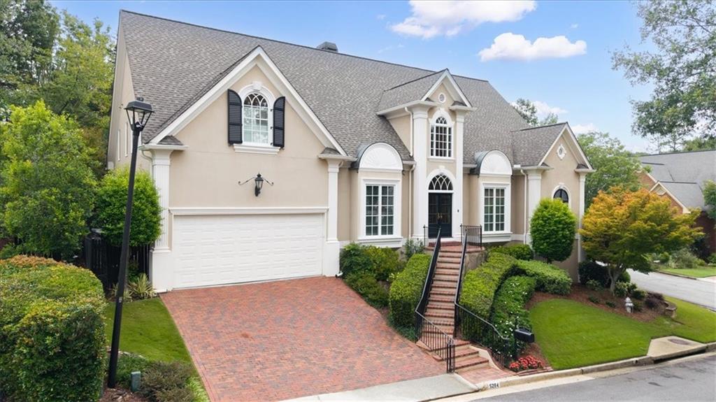 AMAZING opportunity in the highly sought-after and very active Littlebrooke neighborhood of Brooke Farm! This gorgeous hardcoat stucco home was showcased in the Dunwoody Home Tour!
Upon entering your new home, you are met with the bright-2 story foyer with chandelier, adjacent to the banquet size formal dining room. You are then greated by the elegantly designed curved staircase which leads you into the 2 story great room, adjacent to the cozy keeping room and the open concept kitchen that features a large island, a walk-in pantry, and the main floor laundry room. These spaces are accented by floor-to-ceiling windows, hardwood floors, and a double-sided fireplace that sits between these two bright living spaces. And one of the best features on main level of the home is the spacious primary bedroom and large ensuite bath with a barrel ceiling. This spa like bathroom includes double vanities, double custom closets, separate shower, and a jacuzzi-style tub. The stunning staircase leads you to the second level with views into the living area and beautifully detailed Palladian windows that showcase the well-landscaped backyard and courtyard. Upstairs, you will love the functional office space and three oversized-bedrooms, all paired with their own private en-suites. And then, heading down the lovely staircase into the fully finished terrace level that includes an entertainment area with fireplace, wet bar and pool room (possible fifth bedroom) with an additional full bath. There is also a second office with built-ins adjacent to the rare third-car garage; this office can be converted to an additional 4th garage if needed and is perfect for the car enthusiast! And wait until you see the workshop!
The cluster homes in Littlebrooke enjoy maintenance-free lawn care (billed separately from HOA annual dues), and all of the amenities of Brooke Farm, including tennis & pickle ball courts, pool, clubhouse and a five acre private lake! Close to convenient Dunwoody and Perimeter area shopping and dining!