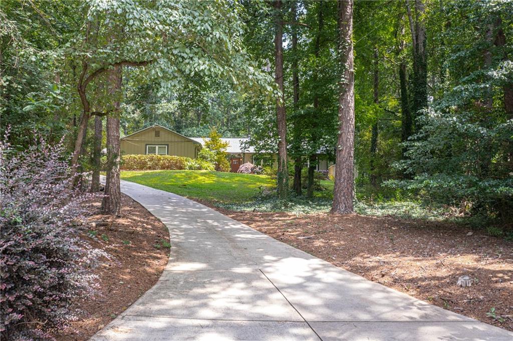Charming Ranch with Modern Updates and Private Outdoor Retreat. Welcome to this beautifully updated ranch home full of character, nestled on a quiet, private lot with a long driveway and fully fenced backyard—perfect for relaxation, entertaining, and enjoying the outdoors in peace. This spacious 3-bedroom, 2-bathroom home features an open-concept floor plan with newer floors, recessed lighting, and updated light fixtures throughout. The kitchen has been thoughtfully renovated and flows seamlessly into the family room, which boasts a striking brick accent wall for added warmth and charm. The large primary suite offers comfort and privacy with updated finishes. Enjoy outdoor living on the expansive front porch or host gatherings in the generously sized backyard. A new roof was installed in 2021, and both AC units were replaced in 2018—giving you peace of mind and energy efficiency for years to come. Located in a vibrant and welcoming neighborhood, you'll have access to outstanding community amenities including a Junior Olympic-size swimming pool, six tennis courts, a stocked fishing pond, and a scenic park with a waterfall and a rustic car-and-horse carriage bridge. The community also hosts frequent events, making it easy to connect and feel at home.
Conveniently close to top-rated schools, shopping, parks, and with quick access to the interstate—this home truly offers the best of comfort, community, and convenience.