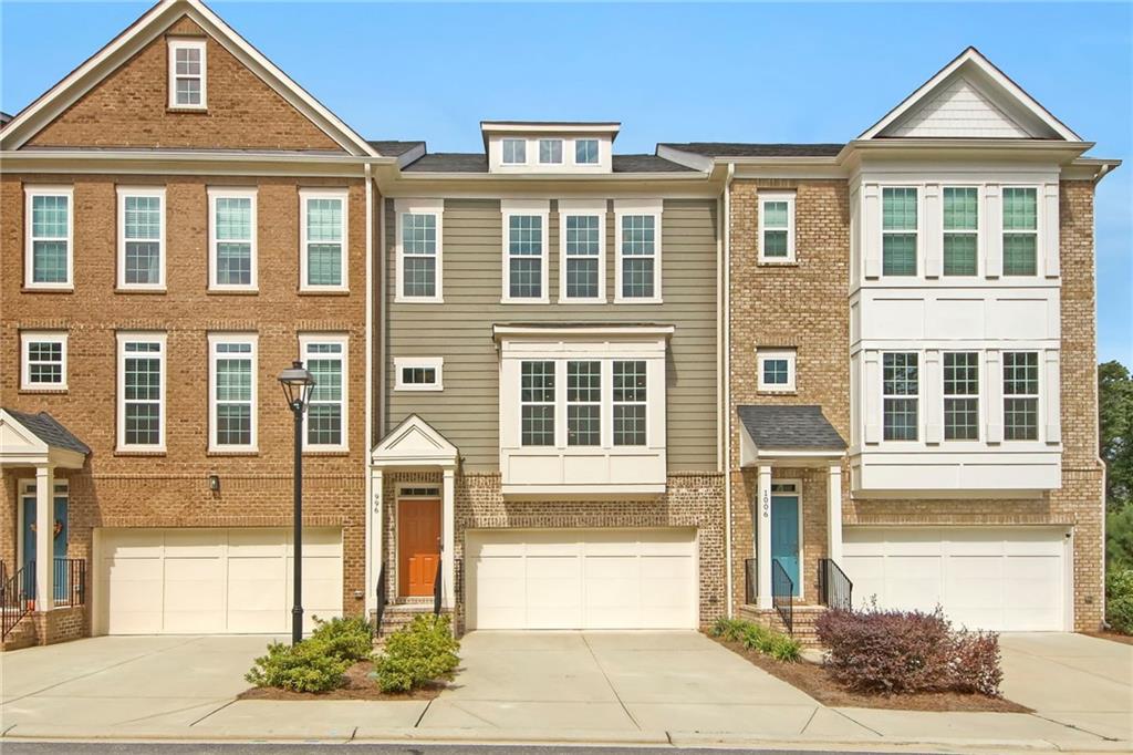 This refined townhome is now available for lease and move-in ready! Ideally located between Suwanee and Sugar Hill, you’ll enjoy being just minutes away from parks, trails, top-rated schools, and vibrant local amenities. Inside, the spacious open floor plan features soaring ceilings and beautiful hardwood floors that create an inviting atmosphere. The chef’s kitchen is equipped with a 5-burner gas cooktop, vented hood, and built-in microwave and oven, perfect for everyday cooking and entertaining. The private lower-level suite includes a full bathroom, offering ideal flexibility for guests or a home office. Upstairs, the primary bedroom is thoughtfully positioned for privacy, with serene views and no direct rear neighbors. Two outdoor living spaces provide ample room to relax and unwind — a large elevated deck with a retractable awning and a shaded lower patio with privacy shades for year-round enjoyment. The HOA covers exterior and roof maintenance, making for worry-free living. Don’t miss this rare rental opportunity — schedule your showing today and make this elegant townhome your new home!