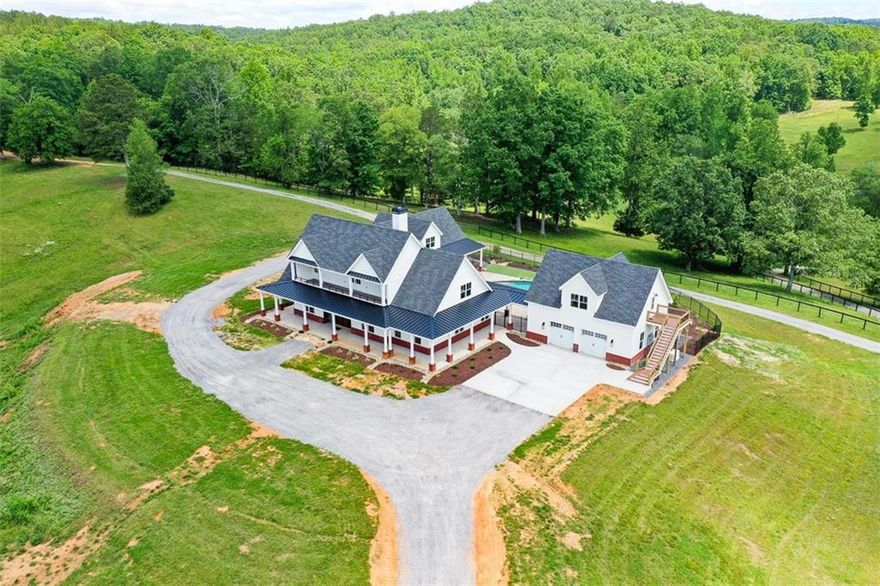 SELLER MAY CONSIDER SUBDIVIDING PROPERTY! RARE AND IMPRESSIVE NEW CONSTRUCTION FARM HOME WITH POOL, 4-CAR GARAGE, IN-LAW SUITE WITH MULTIPLE POLE BARNS, PASTURES, STORAGE AND A SECOND 5 BEDROOM 5 BATH MODULAR HOME, WITH 2 KITCHENS, PLUS A TINY HOME (CURRENTLY STORAGE) ON 145+/- BEAUTIFUL ACRES ONLY MINUTES TO AMAZING RESTAURANTS AND SHOPPING IN CANTON GA. 1 HOUR TO HARTSFIELD JACKSON AIRPORT, 1.5 HOURS TO CHATTANOOGA TN, 30 MINUTES TO CARTERSVILLE GA AND ABOUT 50 MINUTES TO ELLIJAY GA. MAIN BARN HAS 100x40 UNDER ROOF WITH CONCRETE FLOORS, GARAGE DOORS AND 4 RUNS PLUS 2 FEED ROOMS! THERE'S AN 80x60 PULL-THRU POLE BARN FOR YOUR MOTORHOME, RV'S, TRACTORS AND TOYS -- CONTAINER STORAGE UNIT AND 2-STORY TINY HOME BEING USED FOR STORAGE COULD BE USEABLE WITH SOME MODIFICATIONS. PROPERTY IS ROLLING AND BEAUTIFUL WITH ACCESS ON ADDINGTON, 140 AND SALACOA ROAD. THE NEW CONSTRUCTION HAS BEEN METICULOUSLY PLANNED AND THOUGHTFULLY DESIGNED FOR THE ULTIMATE IN FARM LIFE ENJOYMENT AND RELAXATION. OVERSIZED 2-CAR GARAGE AT KITCHEN SIDE OF HOME HAS BUILT-IN CABINETS AND DRAWERS, PLUS A WASH BASIN SINK AND OPENS TO POOL AREA. GARAGE ENTERS TO FULL-SIZED "PANTRY ROOM" WITH BUILT-IN SHELVES AND CABINETRY. THE MORE THAN AMAZING KITCHEN HAS THE LARGEST CAMBRIA COUNTERTOPS THAT YOU CAN IMAGINE WITH UPGRADED FAUCETS AND LARGE CERAMIC FARMHOUSE SINK. MASSIVE ELECTROLUX BUILT-IN STAINLESS STEEL REFRIGERATOR, MATCHING STAINLESS SHARP MICROWAVE AND ASKO DISHWASHER COMPLIMENT THE PRO-LINE ILLVE 6-BURNER + GRIDDLE GAS STOVE AND OVEN. PROPERTY SERVICED BY TWO 500 GALLON PROPANE TANKS FOR COOKING, POOL HEATER AND BACKUP GENERATOR! THIS HOME IS SURROUNDED BY COVERED PORCHES AND THE AMAZING POOL AREA IS NO EXCEPTION, WITH RELAXING SEATING AREAS UNDER SHADE, WITH WATERFALL FEATURE AND LOUNGING SHELF, ARTIFICIAL TURF SURROUNDS POOL AREA FOR LOW MAINTENANCE. GUEST HOUSE OR IN-LAW SUITE HAS 2 OVERSIZED GARAGES WITH BUILT-IN CABINETS AND OVERLOOKS POOL AREA -- BATH STUBBED BUT SPACE IS UNFINISHED BUT SHEETROCKED -- AMAZING STORAGE OR GAME ROOM, HERE IS A LIST OF THE FEATURES OF THIS PROPERTY WHICH BENEFIT THE NEW OWNERS: 2 feed rooms. Separate run-in shed in one pasture. 2 other sheds. Container for storage with electric. Small storage building with electric. 2 story building with kitchen area that needs a few items to be an apartment. Block building for storage with electric. House with 5 bedrooms and 5 baths and 2 kitchens. Landscaping at house with pool. Trails already cut thru out the property. Roads thru out the property. Very private, there are 26 acers of fenced pasture. Over 1,700 feet of potential commercial road frontage on State Route 140. Over 1320 feet of road frontage on Salacoa Road. Over 210 feet of road frontage on DeBord Drive. Custom Blinds in whole house. Heated towel racks in Master Bath and other downstairs bath. Ceiling fans in all rooms. Master bedroom opens onto pool area. All baths have custom tile. All baths have frameless glass shower enclosures. Walk-in spa tub in master bath. Two master bedroom closets. Custom cabinets thru out the house. TV in master bedroom, master bath, downstairs bedroom, downstairs bath, great room, and office. Cambria Quartz surfaces in kitchen--counters and backsplash. Drawer microwave. Built in freezer and refrigerator. Beverage refrigerator. Ilvie dual fuel range. Large walk-in pantry. Granite top on vanity in powder room. Large mud/laundry room. Office with custom built-in desks and cabinets. Lots of closets. 2 bedrooms with bath each upstairs. Porch upstairs with tile floor. Marvin fiberglass windows and doors. Mahogany grand entry door. Huge finished bonus room. All concrete finished with the Guardian finish--garages, porches, and parking pads Pool with amazing waterfall Hot tub. Cabinets in both garages. Detached garage has apartment fully finished. Washer dryer stack in apt. Separate heat and air in apt. 145+-AC Barn concrete floor--5 garage doors in barn. Run in areas for animals. Auto water for animals.