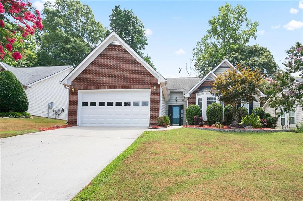 Charming 3-bedroom, 3-bath ranch on a quiet cul-de-sac in Lawrenceville! This light-filled home features vaulted ceilings, a cozy fireplace, and a spacious kitchen with stainless steel appliances and a breakfast nook. The oversized primary suite includes a walk-in closet and a renovated bath with dual vanities, soaking tub, and separate shower. Enjoy a private, fenced backyard perfect for relaxing or entertaining. Located in a well-kept neighborhood with low HOA fees and top-rated schools nearby. Move-in ready and minutes from shops, dining, and major highways this home has it all!