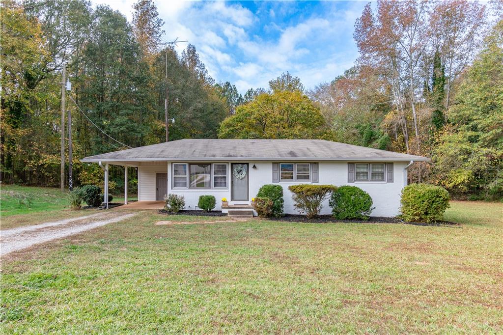 This 60's gal is sitting on almost two absolutely beautiful acres. Brick ranch that is completely renovated! All electric home. Gorgeous hardwood floors. Designer tile in the kitchen. Updated appliances and dark cabinets. Huge, flat front yard would be perfect for holiday get togethers. Two out buildings. One with power. Perfect for the weekend warrior, or someone who owns their own business and needs storage. First time homebuyer? Great way to enter in the world of home ownership! Septic pumped in August 2024. Encapsulated crawlspace completed in May 2024 by Crawlspace Medic. The home also has a transferable home warranty. USDA eligible! Sellers looking to relocate.