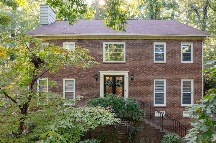 Welcome to this classic and beautifully updated brick home located in the highly sought-after swim and tennis community of Lansdowne. This beautiful property offers a perfect blend of modern updates and timeless charm, ideal for comfortable living and entertaining. Upon entering, you are greeted by a welcoming foyer that opens to a bright living room featuring double French doors and an elegant dining room. The spacious family room boasts a cozy fireplace, creating a warm and inviting atmosphere. The adjacent kitchen is a chef's delight, featuring white cabinetry, stone countertops with a stylish tile backsplash, and stainless steel appliances including a gas range. A convenient computer nook/desk and a sunlit breakfast area complete this functional space. The kitchen opens to a charming sunroom, providing seamless access to the outdoors. Step outside to enjoy the expansive deck, complete with a covered hot tub and patio area, overlooking the private backyard perfect for outdoor gatherings and relaxation.The upper level features an oversized owner's suite with a tray ceiling and a luxurious updated bath. The ensuite includes a vaulted ceiling with a skylight, a double vanity, a separate shower, and a freestanding soaking tub. A large custom walk-in closet provides ample storage. Three additional secondary bedrooms share a well-appointed hall bath. The laundry room rounds out the upper level. The finished terrace level offers exceptional versatility, featuring a kitchen, bedroom, full bath, a second laundry area, and a separate entrance ideal for an in-law suite or guest accommodations. Located in a vibrant neighborhood with outstanding amenities including a clubhouse, pool, tennis courts, and a serene lake, this home is perfectly situated near shopping, dining, parks, and major highways (I-75 and I-575). It is also within the highly acclaimed East Cobb School District, offering top-rated educational opportunities. Don't miss the opportunity to make this exceptional home yours!