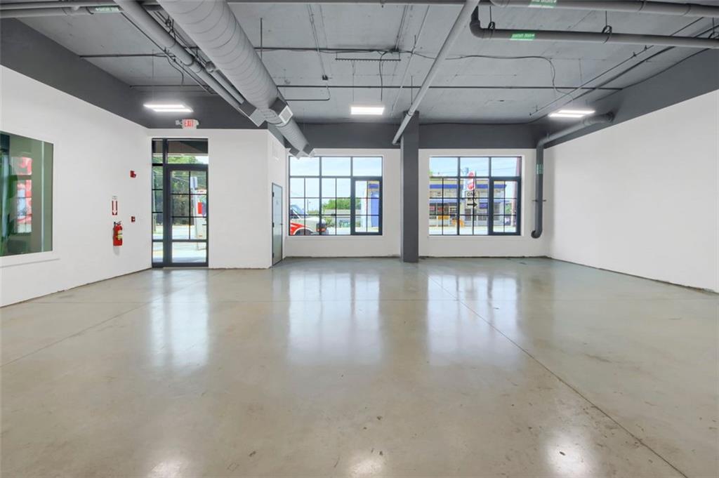 Prime commercial opportunity in the heart of Atlanta’s vibrant Castleberry Hill Arts District! This 1,250 sq. ft. C2-zoned space at Lyric Loft features soaring 12-foot ceilings, an open floor plan, and a full bathroom, offering flexibility for a wide range of business uses. With drain and hot/cold water access, the property is ideal for boutique retail, professional office, wellness studio, creative production, or specialty service-based business. C2 Zoning Permitted Uses Include: * Retail shops, showrooms, and galleries * Offices (professional, administrative, and creative) * Personal and business services (salons, wellness, fitness, tech hubs) * Specialty restaurants, coffee shops, or beverage concepts *(without hooded kitchen equipment)* * Studios for art, photography, or design Located just blocks from Mercedes-Benz Stadium, State Farm Arena, and Georgia World Congress Center, the space benefits from excellent visibility and strong foot and vehicle traffic. Lease includes 3 private, gated parking spaces conveniently located across the street. *Please note: No kitchen hood or grill—space not suitable for full food preparation.* This is a rare opportunity to secure a versatile commercial space in one of Atlanta’s most dynamic neighborhoods. Schedule a showing today to envision the possibilities for your business! Lease Term: Minimum 5 years Security Deposit: Equivalent to 1–2 months’ rent, due at lease signing. First Month’s Rent: Due at lease execution. Business & Financials: Tenant must provide: Business formation documents (LLC/Corp, trade name, etc.) Recent financial statements or tax returns (2 years if available) Business plan for new/startup ventures Creditworthiness: Landlord reserves the right to run business and/or personal credit checks on principal(s). Insurance: Tenant required to carry General Liability Insurance ($1M minimum coverage) naming landlord as additional insured. Permitted Use: Must align with C2 zoning allowances (retail, office, service, studio, beverage concepts). No full food prep (no kitchen hood or grill). Tenant Improvements: Any build-out subject to landlord approval.