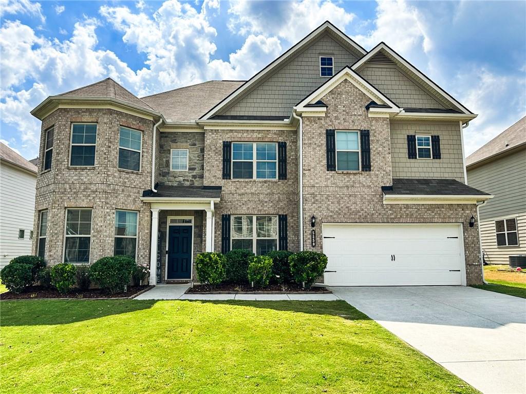 A stunning east-facing brick-front home in Whisper Point - Cumming, Georgia, just hit the market! This spacious 6-bedroom, 4-bathroom gem boasts custom fixtures, 9-foot ceilings, and stylish window blinds throughout. The kitchen, family room, and dining area feature sleek dark vinyl flooring, with the kitchen showcasing white built-in cabinets, granite countertops, and an open entertaining space. The family room includes a cozy fireplace, while the kitchen flows into a backyard oasis with a outdoor entertaining area and large fireplace. The expansive master suite offers a walk-in closet, updated bathroom, garden tub, and a large shower. Four additional bedrooms and three baths are located on the second level, perfect for families or guests. MOTIVATED SELLERS are ready for your best offers. Move-In ready. Don't miss this gem in a family-friendly community with pool and playground amenities. Located in a top-rated Forsyth County school district, minutes from shopping, dining, and GA 400 for easy access to Lake Lanier and North Georgia Premium Outlets.