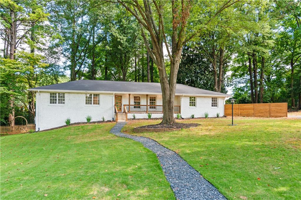 Tucked away on a quiet cul-de-sac just 1.5 miles from vibrant downtown Marietta, this fully renovated four-sided brick ranch offers luxurious one-level living at its finest. Step into a welcoming foyer with an elegant drop zone that opens to a bright, airy floor plan—perfect for everyday living and entertaining. The designer kitchen features custom solid white oak cabinetry, sleek quartz countertops, an expansive island ideal for gatherings, and brand-new stainless steel appliances. The spacious primary suite includes two closets and a stunning en suite bath complete with double vanity, new cabinetry, quartz counters, luxury tile, and striking gold fixtures. Thoughtfully separated for privacy, you’ll find a second en suite bedroom with a beautifully updated bath, plus two additional bedrooms and another stylishly renovated full bathroom. A large laundry room with cabinetry and natural light is conveniently located near the primary suite.
Downstairs, the unfinished basement with exterior entry offers endless possibilities—use it as storage, a home gym, or even finish it into an apartment or media room. For added peace of mind, this home features brand-new plumbing, electrical, and HVAC systems, all completed with proper permits.
Enjoy an unbeatable location close to downtown Marietta, Kennestone Hospital, shopping, dining, and I-75—making your daily routine effortless. Welcome home to comfort, style, and convenience.