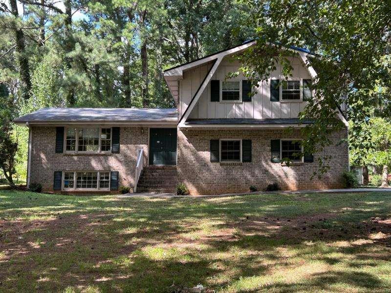 Fixer-Upper Opportunity! Spacious 3-bedroom, 2-bath home with a 2-car attached garage. This inviting property features a large wooded front and backyard, providing privacy and a natural setting. Conveniently located with easy access to I-20 and I-285, it's perfect for commuting and enjoying everything the area has to offer. With some TLC and personal touches, this home has the potential to shine. Don't miss out-bring your vision and make it yours today!