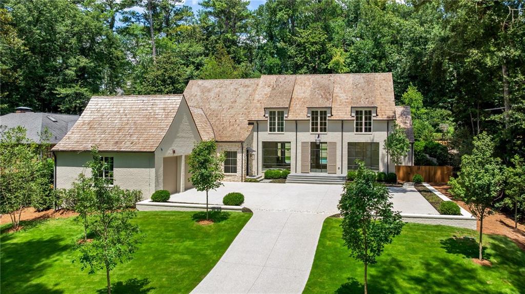 Located in the heart of the sought-after Chastain Park neighborhood of Buckhead, this stunning new construction home by Siegel Construction and Design offers 5 Bedrooms, 6 Baths, and 2 half baths. Approximately 1/2 mile from award winning The Chastain restaurant, Chastain Park Amphitheatre, Tennis Courts and Golf Course. The painted brick and stone exterior features copper gas lanterns, cedar beams, and custom shutters. Inside, the open floor plan showcases clean lines, Venetian plaster, warm white tones, wide staircase, and 4” character-grade white oak floors. Oversized iron doors lead to open and spacious living areas designed for modern living. The chef’s kitchen features custom cabinetry, marble countertops and backsplash, Wolf range oven, Sub-Zero refrigerator, plaster vent hood, and unlacquered brass finishes. A working pantry includes panel-ready appliances and marble surfaces. Enjoy outdoor living on the large covered porch with fireplace and built-in grill, overlooking a walk-out level backyard and pool. The finished daylight terrace level has a recreation room with a wet bar, office area, and gym. Additional space on the terrace level is ready for your customization, or for ample storage area. Built and designed by Siegel Construction and Design, one of Buckhead's most reputable high-end home builders. Don't miss this rare opportunity for luxury new construction in one of Atlanta’s best neighborhoods!