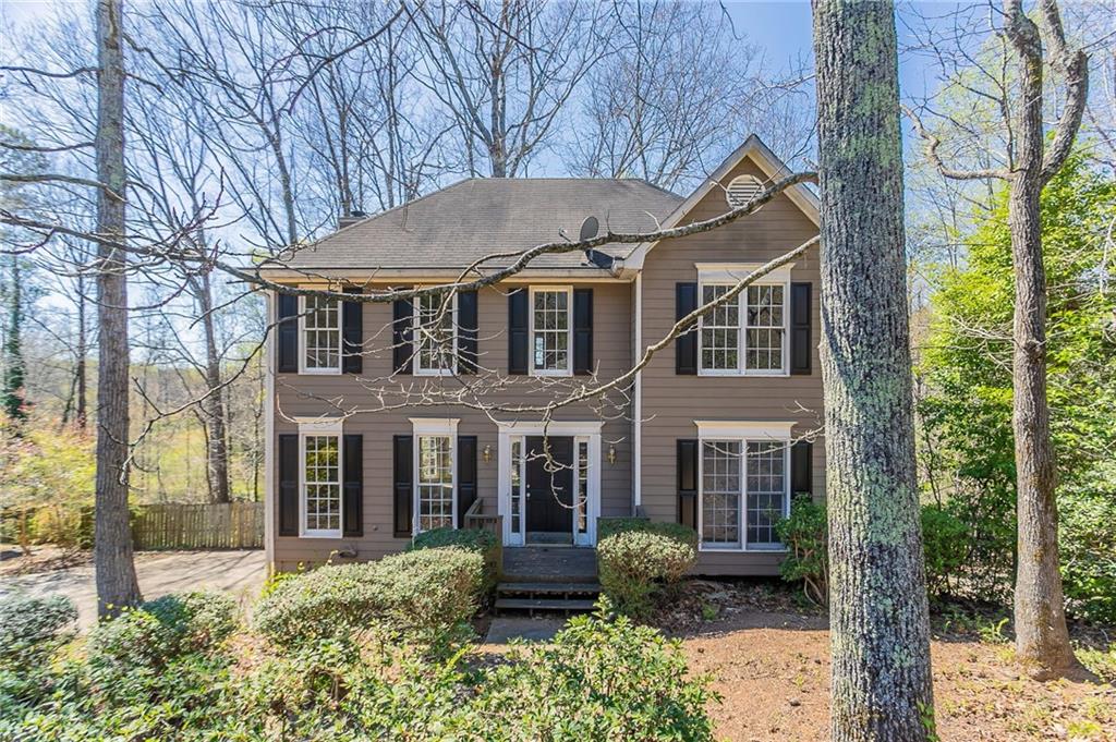 Beautiful curb appeal, an elongated driveway with a two-car garage. The inviting living room features carpeting, a fireplace, and a stunning bay window overlooking the forested backyard. The kitchen boasts stainles steel and black appliances, dark cabinetry, and an eat-in dining area with access to a deck perfect for outdoor relaxation. A powder room is conveniently located off the living room leading to the kitchen. Upstairs, the spacious primary suite offers a spacious closet, an ensuite with dual sinks, a soaking tub, and a separate standing shower. Two additional bedrooms share a full bathroom with a shower/tub combo. The lower level features a separate living space and entrance to the garage, providing flexibility for guests or additional entertainment space. The backyard is enclosed with a wooden fence, offering privacy and serenity. Don't miss this beautiful home! Book your tour today!