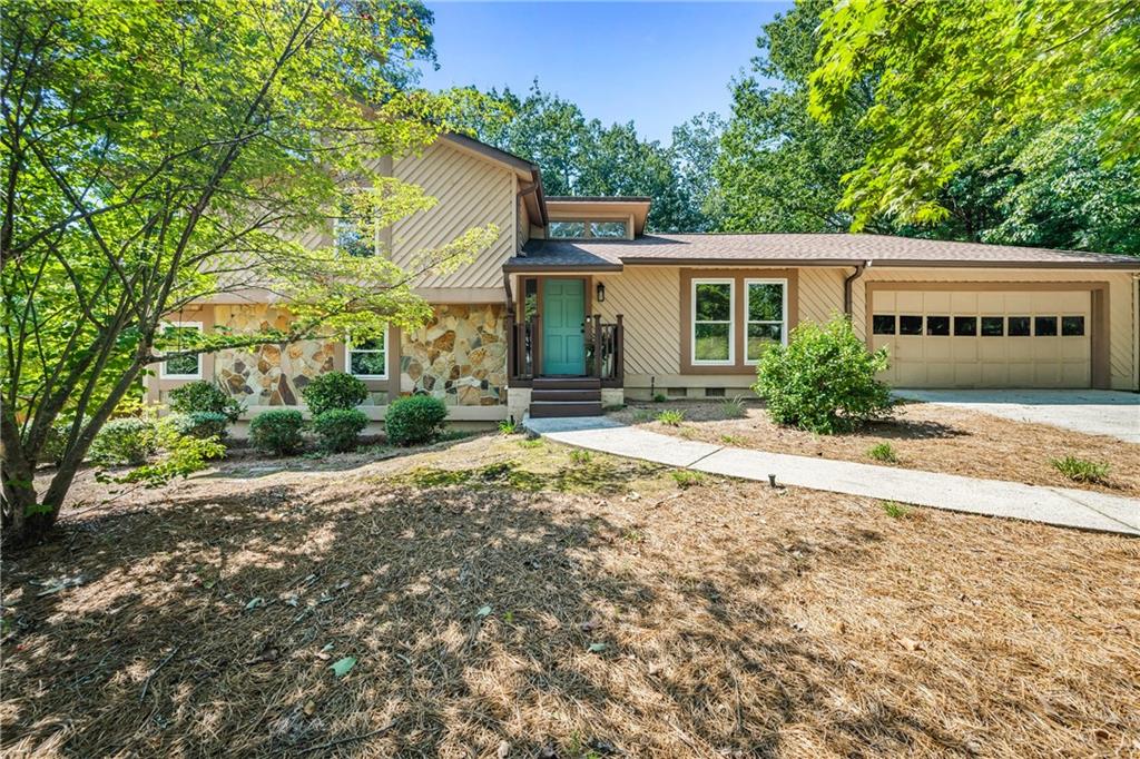 Look no further because this is the one! Welcome to this charming and WELL MAINTAINED 4 bed / 3 bath split-level home in a prime EAST COBB location, just minutes from I-75 for an easy commute and situated in the sought-after Wheeler High School district - Magnet School for Math & Science. Step inside to a BRIGHT and inviting LIVING ROOM and DINING ROOM featuring VAULTED CEILINGS and a skylight that fills the space with natural light. Recent updates, including ALL NEW PAINT, some UPDATED LIGHTING, NEWER WINDOWS, HARDWOOD FLOORS EVERYWHERE - except ONE BEDROOM HAS NEW CARPET, and a refreshed look throughout, making this home move-in ready. Just a few steps down, the FIRESIDE FAMILY ROOM offers the perfect setting for relaxing for entertaining with friends and family. The charming kitchen is equipped with stainless steel appliances, white cabinetry, granite countertops, and a cozy breakfast area—ideal for casual meals and morning coffee. Upstairs, the primary suite offers his and hers closets and a private en suite bath. Two additional bedrooms share a hall bath on the upper level, while the LOWER LEVEL includes a FOURTH BEDROOM, FULL BATH, and LAUNDRY ROOM. The expansive back deck overlooks a private FENCED backyard with a large flagstone patio, offering plenty of space for relaxing, gardening or play. Buy with confidence - the last three neighborhood sales (2024-2025) $520K, $525, $530K. Don’t miss this fantastic opportunity to own a beautiful home with a fresh new look in Woodmont and one of East Cobb’s most convenient locations! Welcome Home!