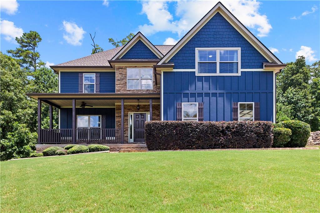 MOVE-IN READY! Convenient to I-85 for commuting! This 5-bedroom, 3.5-bath, 3,569 sq. ft. craftsman home with 2,013 sq. ft. unfinished basement in Persimmon Creek North, features hardwood floors throughout, gourmet kitchen with granite, stainless appliances, gas range, two pantries, custom-painted cabinetry, island and breakfast bar, and eat-in breakfast area. Separate 12 seat dining room. Open floorplan living room features a gas fire place, built-in surround sound, and stunning 12 ft. chauffeured ceiling. Enjoy entertaining on your large, covered back deck that overlooks your fenced backyard. Upgraded fixtures throughout. The primary suite on main level features sitting area, barn doors, large walk-in closet, separate soaking tub and tiled shower, double vanities, linen closet, private water closet, and easy access to laundry room just off the two car garage. Upper level features a large centered loft/media space, and 4 additional bedrooms with jack and jill bathrooms, and large closets. Need more space? Check out the full unfinished stubbed in basement and separate entrance. Make it your own for recreation, income-producing, or multi-generational living. Located in top Coweta schools: Canongate Elementary, Blake Bass Middle, Northgate High. Convenient access to I-85, Peachtree City, Tyrone, and Newnan.