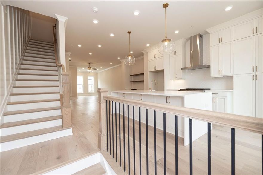 Summer of Savings at Towns on Thompson! MOVE-IN-READY and  FINAL OPPORTUNITIES NOW! $35k ANYWAY ON CONTRACTS WRITTEN IN MAY.. Step into a residence where thoughtful design meets timeless sophistication. This impeccably curated townhome with 10 foot ceilings on main level and hardwoods throughout is a testament to modern luxury, featuring upgraded finishes and architectural details throughout.  MUST SEE HOME!! The stunning and bright kitchen showcases GE Café appliances, industrial slide-in gas range with Stainless Steel hood vent. Bright White Kitchen stacked cabinets with Cambria Calacatta Miraggio quartz countertops, backsplash and oversized kitchen island with waterfall feature and White island cabinets with extra storage and a Farmhouse sink. The kitchen space is illuminated with statement pendant lights and natural light that provides a warm and sophisticated ambiance. The living room/ dining room space includes a beverage center with matching white cabinets and quartz top - perfect for entertaining friends and family. The family room features a sleek linear fireplace with painted Shiplap Horizontal wrapped to the ceiling and cabinet that create an inviting centerpiece. Walk down to the terrace-level suite offering a serene suite bedroom retreat with full bathroom with an elegantly upgraded walk-in shower, perfect for guests or multi-generational living. The upper-level owner's suite exudes tranquility, with an expansive sitting area, custom wall trim, customer-designed closets, and a spa-inspired bath featuring a freestanding soaking tub, with an oversized walk-in shower, and refined finishes throughout. Additional highlights include a sitting room with direct access to open deck! Towns on Thompson- a boutique community of 48 townhomes combining luxury living with exclusive locality. Ideally situated on Thompson Street separating Downtown Alpharetta from Avalon, the possibilities are endless in the heart of vibrant Alpharetta! ~ HOA: Dues include Professional Community Management. Landscaping. Comprehensive Building & Structural Insurance. Say Goodbye to roof maintenance, gutter cleaning, painting/staining, & landscaping! Let HOA cover repair & retreat of termite bond, weekly trash & recycling and so much more! *Homeowners have the optional right to join swim amenities at the Foundry* At TPG, we value our customer, team member, and vendor team safety. Our communities are active construction zones and may not be safe to visit at certain stages of construction. Due to this, we ask all agents visiting the community with their clients come to the office prior to visiting any listed homes. Please note, during your visit, you will be escorted by a TPG employee and may be required to wear flat, closed toe shoes and a hardhat. [The Chamberlain]