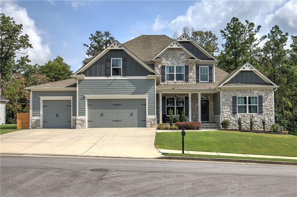 Welcome home to this gorgeous property in the highly sought-after Farm at Edenwood! Better than new, this home blends luxury and comfort with all the upgrades you could want. It features 6 bedrooms, 4.5 bathrooms, a huge 3-car garage, a fully finished basement, and a screened-in back porch with a stone fireplace overlooking the large fenced backyard and peaceful woods behind.
Step inside the two-story foyer and immediately notice the hardwood floors, beautiful millwork, and attention to detail throughout. The open layout flows perfectly, with a dream kitchen that has quartz countertops, a massive island, subway tile backsplash, white soft-close cabinets, upgraded appliances, and a huge walk-in pantry. The kitchen opens to the family room, which features a stone and shiplap fireplace, coffered ceilings, and hardwood floors. From here, a door leads to the screened porch—perfect for relaxing or entertaining. Just off the kitchen, there’s a convenient drop zone and laundry room that connect to the 3-car garage.
On the other side of the foyer, the formal dining room makes a beautiful impression with transom windows, judges paneling, and coffered ceilings. The owner’s suite is a true retreat, with a double tray ceiling, crown molding, a spacious walk-in closet, and a spa-like bathroom featuring a large tiled shower with seamless doors, soaking tub, dual vanities with stone countertops, and ceramic floors. Both the main floor and back porch have a Sonos sound system for added enjoyment.
Upstairs, you’ll find a flexible loft that can serve as an office or study area, along with four spacious bedrooms and two full bathrooms. The fourth bedroom is extra-large, perfect for a media room, teen hangout, or playroom. The recently finished terrace level adds even more space for entertaining, with two living areas, an office, a large bedroom with a full bath, and plenty of storage. It also opens to the rear patio, lawn, and backyard.
Living in the Farm at Edenwood means access to amazing community amenities, including a clubhouse with fitness center, a triple water park, Jr. Olympic pool, waterslide with plunge pool, zero-entry pool, lighted tennis courts, and a playground. Nearby recreation includes Governor's Towne Club, Lakepoint Sports Complex, Lake Allatoona, Lake Allworth, horseback riding at Moonlight Stables, and Bentwater Golf Club. You’re also close to shopping and dining on Cedarcrest Road, Acworth, Hiram, and West Cobb, as well as nearby health facilities. Located in a top-rated school district, this home is a must-see!