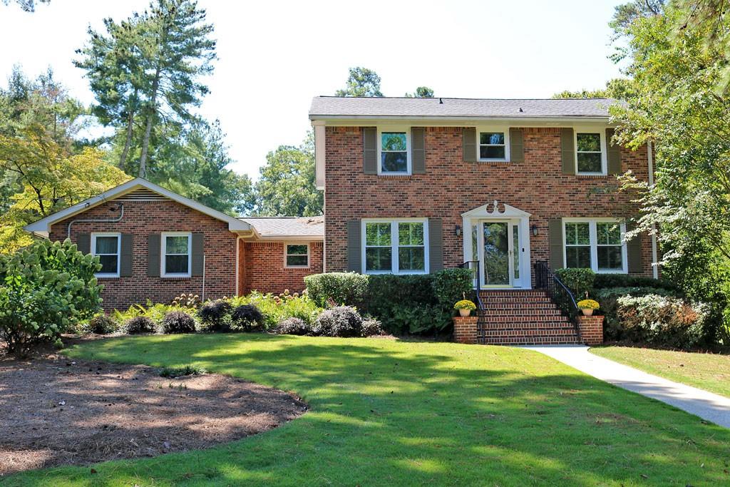Beautifully maintained Brick traditional on corner lot in quiet neighborhood. This home has been renovated to add an additional 560+ sq. ft to expand the kitchen, breakfast room and family room. The beautifully updated kitchen has a cathedral ceiling, SS appliances including double ovens and smooth surface cooktop, custom cabinets, granite counter tops, a huge island and pantry. Large arched opening gives a great view to the oversized family room. The family room has built-in cabinets built-in seating with storage, a masonry wood burning fireplace with french doors leading to the separate living room. The large separate dining room is perfect for gatherings. The main floor also features a full bath with walk-in shower a large laundry room and multiple storage cloests/pantries. The updated Master Suite has bath with a tiled walk-in shower, large vanity and linen closet. 3 additional bedrooms up with 3rd full bath that has tub/shower combo and dual sinks. Finished daylight basement has a large media/flex room with built-in shelves, a wood burning fireplace, and plenty of additional storage. Large deck off kitchen over looks back yard and has been recently updated with composite decking. 3 sides brick with fiber cement siding in rear. 2 car rear entry garage with automatic opener. Outbuilding for storage. Close to parks, lake, shopping and walk to school!
