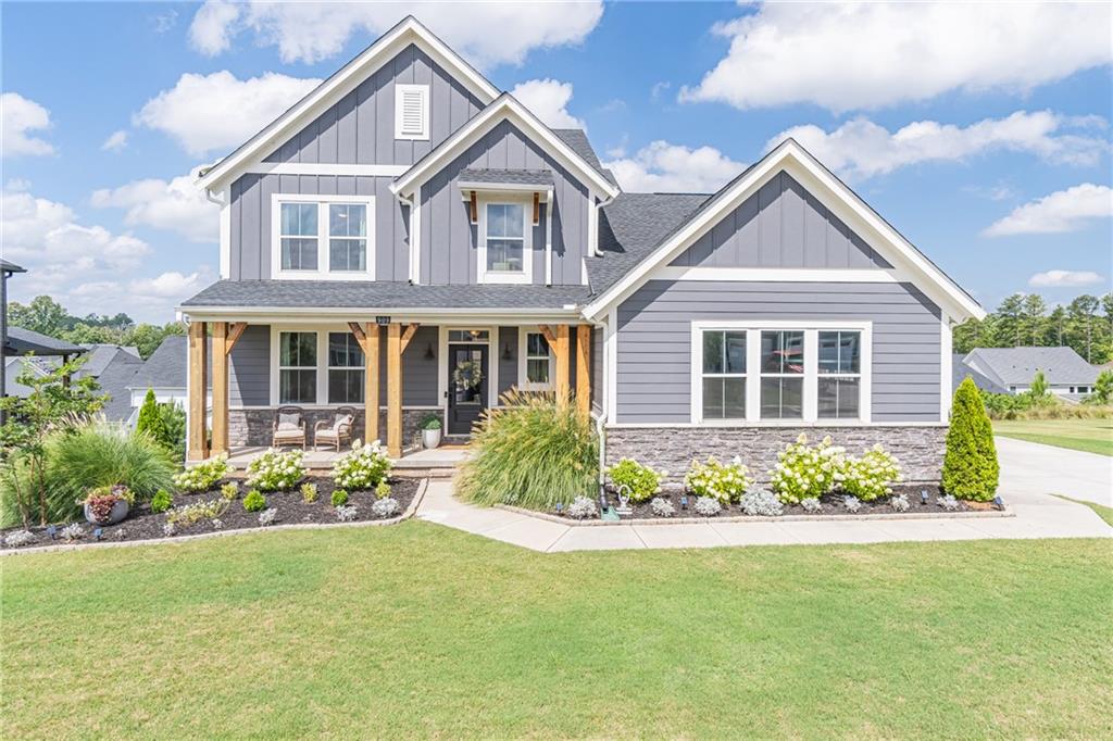 Welcome to this designer home situated in the beautiful community of Twin Lakes! A home that truly offers it all! Upgrades galore, an open floor plan and tons of natural light. The living room is open to the kitchen with white oak cabinetry and white quartz counters. The owners suite on the main level features a stunning double shower and an upgraded closet system. Upstairs are two secondary bedrooms and a full bathroom. The upstairs loft is amazing! The custom wet bar leads to a dining/living area that is perfect for entertaining. All of this on a finished basement with a bedroom and designer bathroom. The basement is a walk out to the backyard and has expanded patio space! Come enjoy this nearly new construction home!