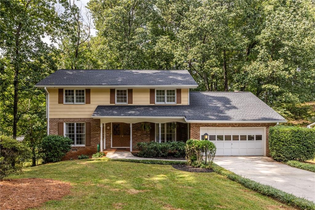 A Rare Gem in the Midvale Elementary District! Your search for the iconic American Dream Home ends here. This lovingly cared-for four-sided brick traditional two-story home has been cherished by one family since 1967 and offers four bedrooms and three full baths, including a main-floor bedroom and bath perfect for multi-generational living or a home office. You're welcomed by a covered and terra cotta floor front porch, big enough to sit and take in the neighborhood. Step inside to a formal living and dining room, or move into the kitchen that opens to the sunken den with pegged hardwood floors beneath the carpet, a wood-beamed ceiling, and a brick fireplace with gas logs flanked by built-in bookcases. Lovely natural wood French doors lead to a screened porch overlooking the serene backyard and its treetops. The charming eat-in kitchen features real wood cabinets with abundant storage, Corian countertops, and a built-in work nook. And don't forget the partially finished basement with a retro tufted bar provides endless opportunities for entertaining and more. All bedrooms are generously sized with plush carpeting over hardwood floors. The oversized primary suite has space for a king bed, a sitting area, and a walk-in closet. The primary bath is elegant and functional with a walk-in shower, double vanity, and linen closet. Secondary bedrooms feature large closets with built-in shelving for added organization, and wide upstairs hallways with a classic banister create a smooth flow throughout the upper level. The nine-foot ceiling unfinished basement offers a workshop and walkout to the backyard, providing even more space for storage or projects. The backyard includes multiple areas for entertaining and relaxing, from a patio with garden potential to a screened porch, and convenient storage under the terrace. Deer can frequently be seen running through the property. IMPORTANT UPGRADES - NEW Architectural Grade Shingled Roof and Gutters with transferable warranty(Sept. 2025); Sewer line from house to street replaced (2024); NEW Hotwater Heater(2024); and pressure-washed exterior, including driveway and walkways, and a yard freshly winterized with pinestraw.
Located on a charming, neighborly street with multiple cul-de-sacs leading to a quiet dead end, this home provides access to Henderson Park via several foot trails, a tucked-away grassy knoll by a creek, offering abundant opportunities to enjoy the outdoors. It sits right next to Henderson Park with trails, Lake Erin with multiple docks, playgrounds, soccer fields, tennis courts, and a community garden. Nearby amenities include multiple swim and tennis clubs as well as the public pool at Kelley Cofer Park, the vibrant heart of Downtown Tucker, more than four grocery stores, shopping, restaurants, Mercer University, I-285, and easy access to Emory, CDC, and CHOA. This home combines timeless charm, flexible spaces, and remarkable potential. Whether you choose a simple refresh of paint and cabinets or a full custom remodel, the opportunity is extraordinary.