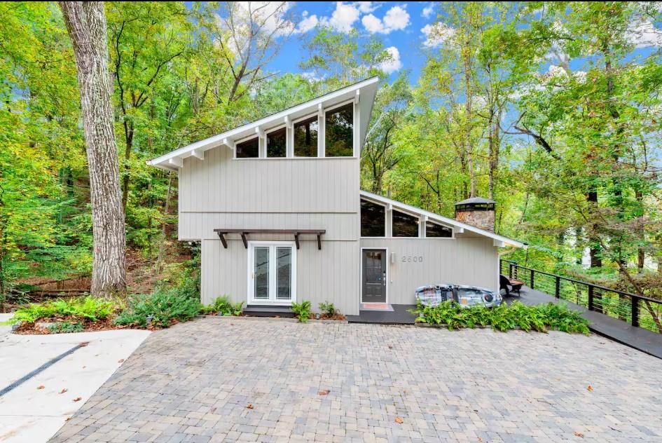 Think cabin meets lake house Experience everyday vacation living in this stunning, fully remodeled Mid-Century Modern lake retreat. Located on a quiet cul-de-sac in a serene lake community, this meticulously maintained home offers the perfect blend of comfort, privacy, and convenience. Enjoy expansive open water views from your single-slip platform dock with a party deck, swim deck, dual-railed ramp, and full utilities including water and electricity. Nestled on a deep water cove at the corner of Little River and Wahoo, the property offers beautiful year-round views and seasonal glimpses of the lake. Inside, the home features high-end upgrades throughout, MASTER ON MAIN. Two Bedrooms upstairs sharing One bathroom.A finished terrace level with a custom wet bar, microwave, dishwasher, and refrigerator—ideal for entertaining. Relax on wrap-around decks on both levels, with the lower deck boasting a private Jacuzzi spa for ultimate relaxation. Currently a cash-flowing Airbnb, this home is perfect as a personal getaway or investment opportunity. Location is great. Mins to the grocery store, gas station and all the restaurants in downtown Gainesville.