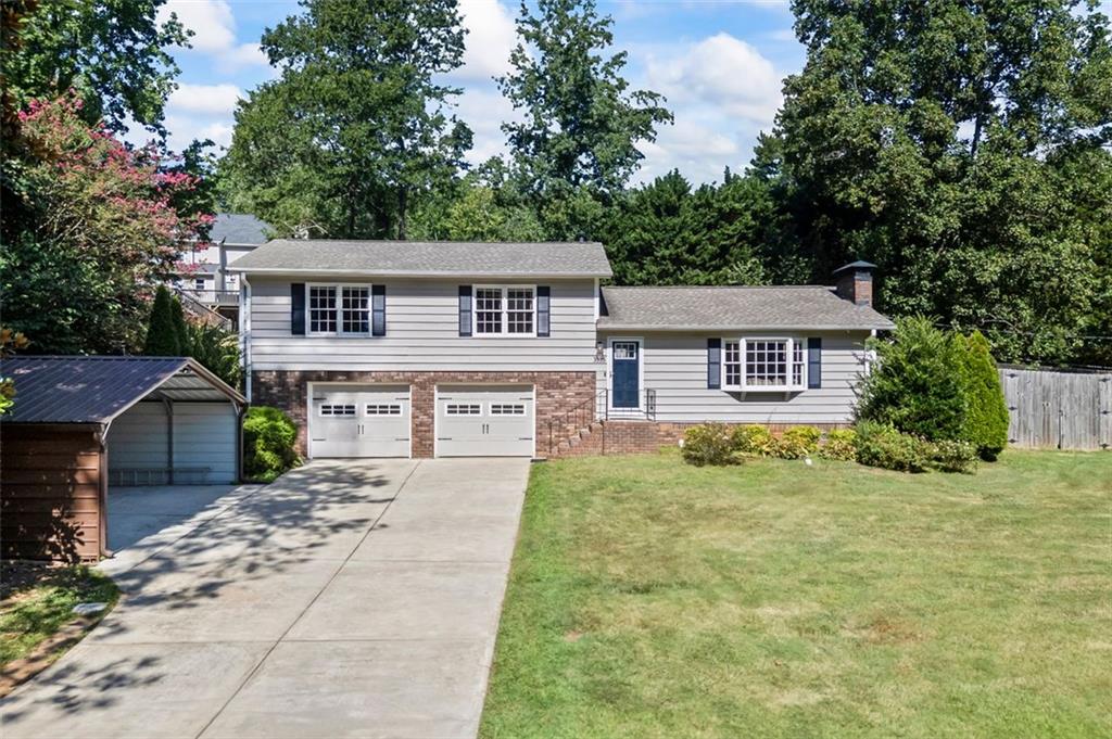 This East Cobb home checks all of the boxes! Located on a quiet street with no through traffic, it delivers convenience plus space, privacy, and style! Featuring an open plan perfect for entertaining with luxury vinyl plank flooring and a fireside family room with built in bookcases. The spacious kitchen is built for action—tons of cabinets, expansive counters, and room to move. Upstairs, the primary suite features a sleek double vanity and custom tiled walk-in shower, with two additional bedrooms and a full modern bath. Grill and Chill out back, on the oversized deck that wraps around for your future outdoor kitchen. The huge backyard is fully fenced and perfect for gardening and play! Separate Workshop/Building includes electricity and air compressor plumbing for your mancave/she-shed. Enjoy the oversized two-car garage with plenty of storage space, extra covered parking for your boat or toys! PLUS the added benefits of a well built home, including a spray foam insulated attic, AquaGuard encapsulated crawlspace, and absolutely NO HOA. Minutes from top schools, shopping, dining, entertainment, KSU, interstates, and so much more! Rumored to have famous roots, this house really does have it all! Save on closing costs using our preferred lender, too!