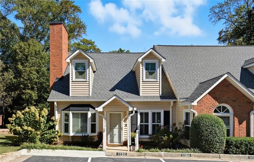 Charming End-Unit Townhome Near Historic Roswell. This beautifully maintained end-unit townhome offers effortless functionality and comfortable living. The open-concept layout connects the living room, dining area, and kitchen, creating a perfect flow for everyday living and entertaining. Step outside to the back deck overlooking a private wooded view. The primary suite on the main level features a renovated bath with a walk-in shower, custom tile, and stylish vanity, plus a spacious walk-in closet. The inviting living area includes a fireplace with built-in bookcases, Two laundry areas - stackable on main level and laundry in hall on the upper level. 
Two designated parking spaces. Must see this friendly, coveted community, with only 34 units, nestled in the heart of Roswell with pool, fitness center and clubhouse. HOA includes water. Walking distance to everything Canton St has to offer - shopping, restaurants, festivals, parks!