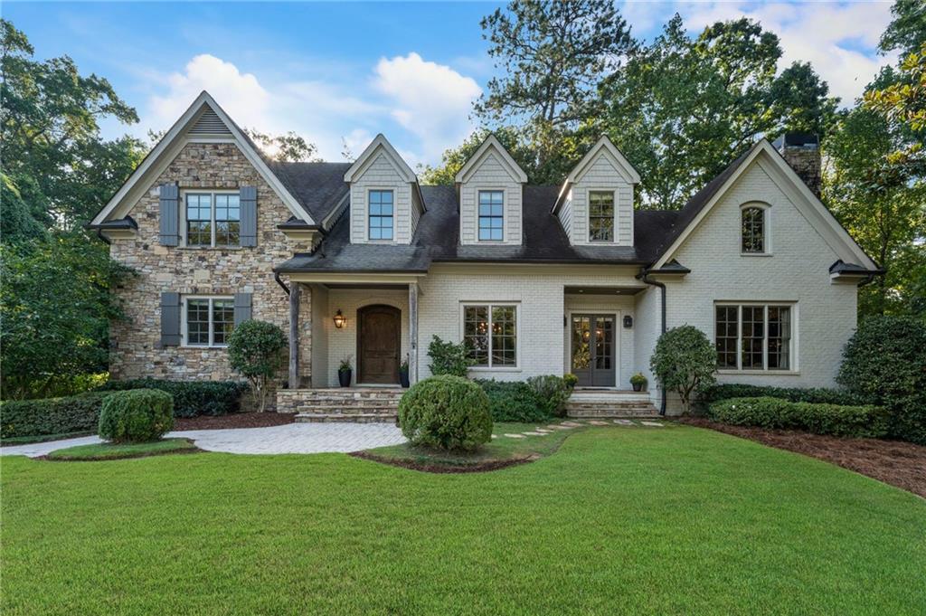Welcome to luxury and comfort in walking distance to Morris Brandon Elementary in the coveted Castlewood neighborhood offers a finished terrace level, rare 4-car garage, stone outdoor fireplace, and a large fenced yard. Located close to top private schools/highways. In the foyer, you are welcomed with soaring 10ft. ceilings and abundant natural light that highlights the architectural details and gleaming hardwood floors. The open-concept living areas are ideal for entertaining and everyday living. A gourmet kitchen with wood beams features a new 8-burner Wolf range, two dishwashers, Stainless Thermador refrigerator, warming drawer, double ovens, marble counters, generous island, breakfast bar, and breakfast room with French doors to a stone patio. The adjacent great room centers around a cozy fireplace with French doors to the deck. The opulent primary suite is a private retreat with a travertine bathroom, dual vanities, soaking tub, separate shower, and dual closets. A charming dining room is perfect for entertaining. A mudroom, pantry, and laundry room complete the main level. Upstairs, three spacious secondary bedrooms each include en-suite bathrooms and ample closets, complemented by a large, light-filled playroom. The finished terrace level provides exceptional flexibility with a large recreational area, 5th bedroom, full bath, and gym or home office. French doors open to a covered porch with stone fireplace and grilling patio, creating seamless indoor-outdoor living. The private, fenced backyard is perfect for play or entertaining. Nestled in the prestigious Castlewood neighborhood, this home combines luxury living with a strong sense of community, minutes to top schools, dining, shopping, and recreation. A rare opportunity to own a true Castlewood gem.