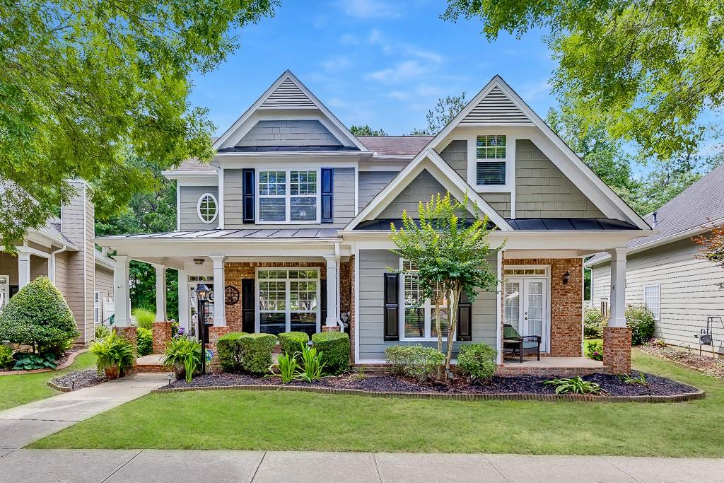 Priced to Sell! Move-In Ready with a Brand-New Roof! Welcome to this beautifully maintained 3-bedroom, 2.5-bath Craftsman-style home in the highly sought-after North Gwinnett School District. Tucked away in the heart of charming Old Suwanee, this home blends timeless curb appeal with modern updates including a brand-new architectural roof. Enjoy a classic rocking chair front porch, mature landscaping maintained by the HOA, and authentic Craftsman details throughout. Inside, bright and open living spaces feature soaring ceilings, elegant trim work, and an abundance of natural light. The dramatic two-story family room creates a warm, welcoming atmosphere for everyday living or entertaining. The updated kitchen boasts granite countertops, new stainless steel appliances, and ample cabinetry, flowing into a sunny breakfast area that opens to a second covered front porch ideal for morning coffee or casual gatherings. The main-level primary suite features tray ceilings, a spacious walk-in closet, and a spa-like en-suite bath with dual vanities, soaking tub, and separate shower. Upstairs, two additional bedrooms and a renovated full bath offer privacy and comfort for family or guests. Step outside to a covered patio and fully fenced backyard, perfect for relaxing, entertaining, or spending time with pets. All just minutes from Suwanee Town Center, parks, greenways, and top-rated shopping and dining this home truly checks all the boxes!