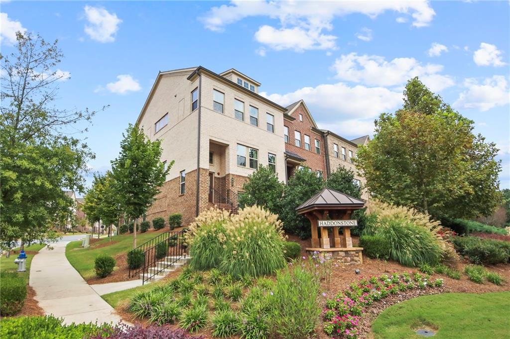 END UNIT with Tons of natural light! Discover modern luxury and convenience! This 4 Bedrooms 3.5 bathrooms three-story townhome provides flexible living spaces. The first floor offers a private bedroom and full bath, perfect for a guest suite, home office, or a family member seeking a quiet retreat. The second floor is the heart of the home, featuring an open-concept design that seamlessly blends the sun-filled living room, dining area, and a gourmet kitchen, which opens out to the deck with a fabulous view of the community. The third floor is dedicated to rest and relaxation. A spacious owner's suite provides a peaceful sanctuary with a spa-like ensuite bath. The third floor also includes two additional bedrooms and another full bathroom, offering plenty of space and privacy for the entire family. The home features beautiful hardwood and carpet flooring, a fireplace for cozy evenings, and modern fixtures throughout. Situated less than a minute from I-575, this home offers an incredibly easy commute. You're also just a short drive from the Woodstock Outlet Shoppes at Atlanta, Costco, and a variety of other shopping and dining options. Enjoy the vibrant charm of downtown Woodstock, which is within walking distance and offers a plethora of restaurants, boutiques, and community events. This property is zoned for excellent Cherokee County schools, including Woodstock Elementary, Woodstock Middle, and Woodstock High School. Residents of this community enjoy access to a swimming pool, and the HOA fee includes landscaping and trash services, providing a low-maintenance lifestyle. Don't miss your chance to own a piece of Woodstock's best.