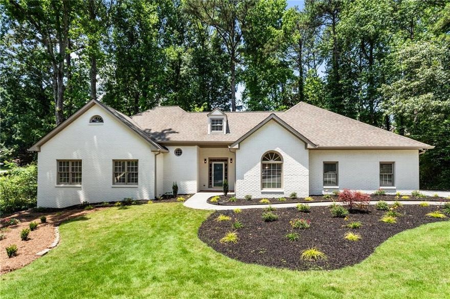 Tucked at the end of a quiet cul-de-sac in the highly sought-after Harrison High School district, this beautifully renovated home blends luxury, comfort, and convenience—just a stone’s throw from The Avenue West Cobb and premier shopping and dining. Inside, you'll find three spacious bedrooms and 2.5 baths on the main level, all enhanced by brand-new LVP flooring that flows seamlessly throughout. The bright, designer kitchen features crisp white 42" cabinets, new stainless steel appliances, a stunning sage tile backsplash, and sleek quartz countertops for a polished, modern finish. Start your mornings in the serene screened-in sunroom just off the kitchen—perfect for enjoying coffee and tending to your plants in peace. The oversized primary suite offers French doors that open onto a private back deck surrounded by nature. Unwind in the spa-like ensuite bath with a freestanding soaking tub and custom-tiled luxury shower. All full bathrooms throughout the home are thoughtfully upgraded with a combination of quartz and granite countertops and stylish tile finishes. Upstairs, two oversized bedrooms share a beautifully updated full bath and are connected by a versatile loft—ideal for a second living area, office, or playroom. A separate formal dining room is ready for entertaining, while the laundry room includes a utility sink for added function. The finished basement expands your living space with a large open area perfect for recreation or a home theater, already stubbed for a full bath. A separate basement-level garage provides an ideal space for a workshop, gym, or extra storage—preserving the main-level garage for daily use. With tons of storage throughout and thoughtful upgrades at every turn, this home offers a flexible layout that fits every lifestyle. Homes of this quality in this school district rarely last—schedule your private tour today.