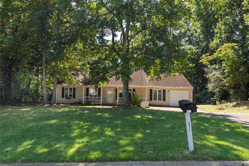Welcome to this spacious ranch-style home in Riverchase, a desirable non-HOA community in Woodstock. Designed with an open-concept layout, the home features a large family room with a cozy fireplace, a dining area, and a kitchen that seamlessly connects the main living spaces. The primary suite includes a private bath, while three additional bedrooms share a hall bath—one of which was thoughtfully converted from garage space. A bonus room offers flexibility for extra living, office, or play space. Step outside to enjoy a generous deck overlooking the backyard, along with a huge outbuilding that provides endless possibilities for storage, hobbies, or a workshop. This estate-owned property is filled with potential, ready for you to bring your vision and transform it into your dream home. Perfectly situated just off Hwy 92, the home offers easy access to Woodstock, Roswell, and East Cobb, and is located within an award-winning school district.