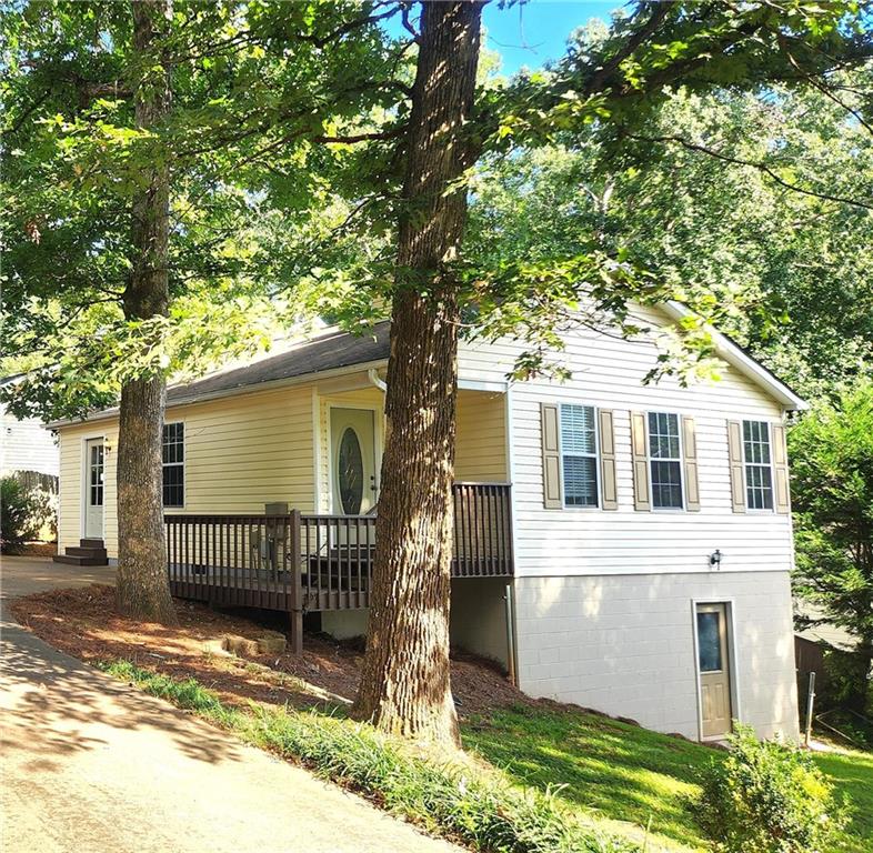 LOCATION LOCATION LOCATION! JUST MINUTES FROM LAKE LANIER w/ easy access to Boat ramps, Parks & Water Activities, GA 400, the OUTLETS, the VIBRANT CUMMING CITY CENTER & SO MUCH MORE!!! SO Many Options to make this your Weekend Getaway, AirBnb Rental, or Home!! Home is Located in the Tranquil Community of Shady Shores! This 2 Bedroom/ 2 Bath MOVE-In Ready Home features an Open-Concept Living Area! The Kitchen Offers BRAND NEW CounterTops, BackSplash, Sink, Faucets & Plumbing! ALL Kitchen Appliances are Included! Family Room Features a Cozy, Stone Fireplace!! There are also SO MANY Possibilities in the Partial Basement w/ Interior & Exterior Entrance! One Room is almost completely finished and the Crawl Space area was recently Encapsulated offering SO MUCH STORAGE!! Don't miss your OPPORTUNITY to own a Home in a Highly Desirable area!! It is PRICED TO SELL!! COME SEE TODAY!!!
