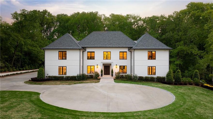 Situated on nearly 6 acres in one of Sandy Springs’ most coveted locations, this gated custom estate is a rare opportunity to own significant acreage just minutes from Chastain Park. Designed by Harrison Design in collaboration with Musso and Falconbury and built by John Willis Custom Homes, this exceptional residence blends modern transitional architecture with timeless craftsmanship.
Spanning over 10,000 square feet, the home offers an effortless flow for both daily living and large-scale entertaining. The main kitchen features custom Pricinsky cabinetry, marble countertops, and a full suite of Sub-Zero and Wolf appliances and a sun-drenched breakfast area. 
Refined architectural detail and custom millwork define the main living room, while the fireside keeping room features vaulted ceilings that add volume and warmth. Expansive sliding doors on both the main and terrace levels open to covered patios, creating a seamless connection between indoor and outdoor spaces.  There are two spacious bedrooms on the main level shared by a bath that could easily be converted to a primary bedroom suite.  One with private access to a patio.  The terrace level is designed for elevated entertaining, complete with a custom bar, game room, rec space, a home gym and a space waiting to be customized for a wine cellar. Outside, the grounds are equally impressive: a large custom pool with limestone decking, expansive covered patio, outdoor kitchenette, and private shower.   Endless possibilities to further build out this property of nearly 6 acres with pickleball court, tennis court, sport court, additional parking garage or guest house.  Seven-inch white oak floors run throughout the home, complemented by limestone flooring on the terrace level. Every finish was chosen with intention—clean lines, natural materials, and a restrained palette create a sophisticated, gallery-like ambiance.
From the custom brickwork to the fully integrated sound and security systems, every detail of this property reflects thoughtful execution at the highest level.  
The result is a refined estate that feels both modern and enduring, set on a truly exceptional piece of land.