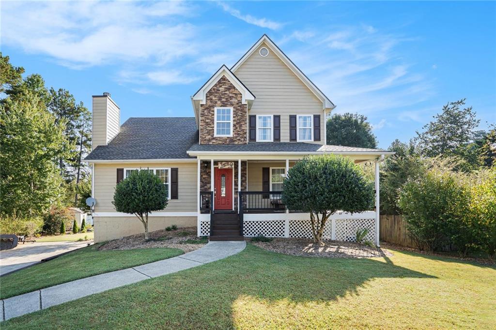 Welcome Home to your oasis! Peaceful neighborhood-lake frontage with fishing dock and a yard that is a gardener's and golfer's delight! Professional putting green and chipping stations positioned around the backyard along with a hitting net for the beginner or avid golfer! So many perennials and landscaped areas make this a lovely yard year round. Cabin-style shed, perfect for meditation or just relaxing with a book. Fire pit, patio, hot tub (can be removed at buyer request) with gazebo. Additional storage shed/workshop can be removed at buyer request as well. Inside you will find new Luxury Vinyl Plank flooring on the main level and a remodeled kitchen with granite countertops and lovely wood cabinetry including a tea/coffee bar - all open to the dining area. Plus a cozy kitchen nook overlooking the gorgeous back yard and pond view. Or enjoy the view from the oversized deck just outside the dining room. Large Primary bedroom suite on the main level and New oak stair treads with new balustrade and handrail gleam on the way to the upper level, with three more bedrooms upstairs. Built in bookshelves and storage in secondary bedrooms for added charm and useful space. On the lower level you will find two more finished rooms, perfect for hanging out or office/bedroom space. One garage has been converted to an office/storage space, but could be converted back by removing the wall. Don't miss this slice of paradise, yet close to schools and shopping and everything you need!