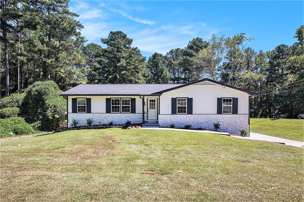 Welcome to this stunning,cozy residence located minutes from 78 Hwy for your convenience! This home is updated with new flooring and carpet throughout, fresh paint throughout, and new roofing. The kitchen is complete with stainless steel appliances, white cabinetry, and new quartz countertops with a breakfast area and separate formal dining space. Adjacently, the family room is complete with a fireplace to warm up after a long day and leads to a new deck outside, overlooking a spacious, lush, level backyard. The master bedroom is located on the main floor and neighbors the updated bathroom, complete with modern tiles and a new quartz countertop on the vanity. There are two additional bedrooms on the main level with an additional bathroom with a new countertop and shower-tub combo. The New garage Doors leads into the basement with additional space which has also been freshly painted. This residence is in an Brookwood school district and is not one that should be passed up! This home is a must-see to be appreciated! NO HOA or Rental Restrictions