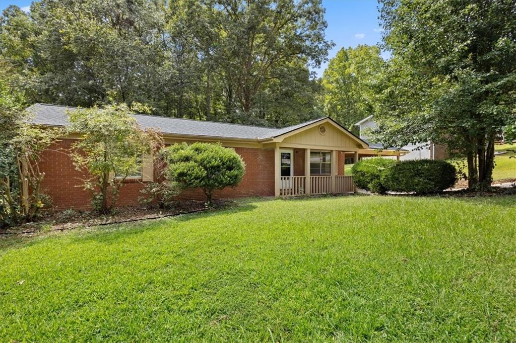 Welcome Home to this well maintained “move in ready” ranch( no stairs zero) in a serene pocket of Douglasville. It combines classic charm with modern convenience… an open bright layout, freshly painted , updated kitchen and living space centered around a cozy fireplace, plus a large deck for all your outdoor living and cooking out, set in your private wooded back yard. This 3/2, traditional ranch on crawl, is minutes to I-20, Arbor Place Mall and Sweetwater State Park, for all your outdoor recreation. It features a carport, brick front and located in family friendly community. Inside you will find, open concept featuring kitchen w/ granite counters, newish cabinets, fridge, dishwasher and electric range, come with home. Ceiling fans in all cozy BR’s. New lighting along with ample closet space. BRAND NEW LUXURY LVP FLOORING THROUGHOUT THE ENTIRE HOUSE! The rent on this home is very competitive and lower than many of the local comps. We are NOT institutional investors or private equity. We DO answer the phone and will provide an exceptional rental experience to only QUALIFIED tenants. What we seek is income at least 2.5 times monthly rent, NO evictions within last 3 years, and completion of a credit, criminal and background check. Ultimate security deposit determined by credit scores. Good income, CAN offset iffy credit. Pets are discouraged, but will be considered on case by case basis with non refundable fee and bump up in monthly rent determined by breed. So if you meet the criteria and will be a good steward, we will welcome you to this lovely home, and treat you very well. You must present proof of renters ins, prior to moving into home. WE DO NOT provide a washer and dryer. NEW water heater just added. Wait… there’s more! ALL NEW ceiling fans, faucets, freshly painted walls, in the perfect neutral color, ceiling and trim as well. All cabinets have been repainted with brand new hardware! PLUS new OVERSIZE back deck for all your outdoor entertaining! ** It's not new, but lots of TLC spent here to make home for YOU.*** RENTAL INCENTIVE FOR HIGHLY QUALIFIED TENANTS***