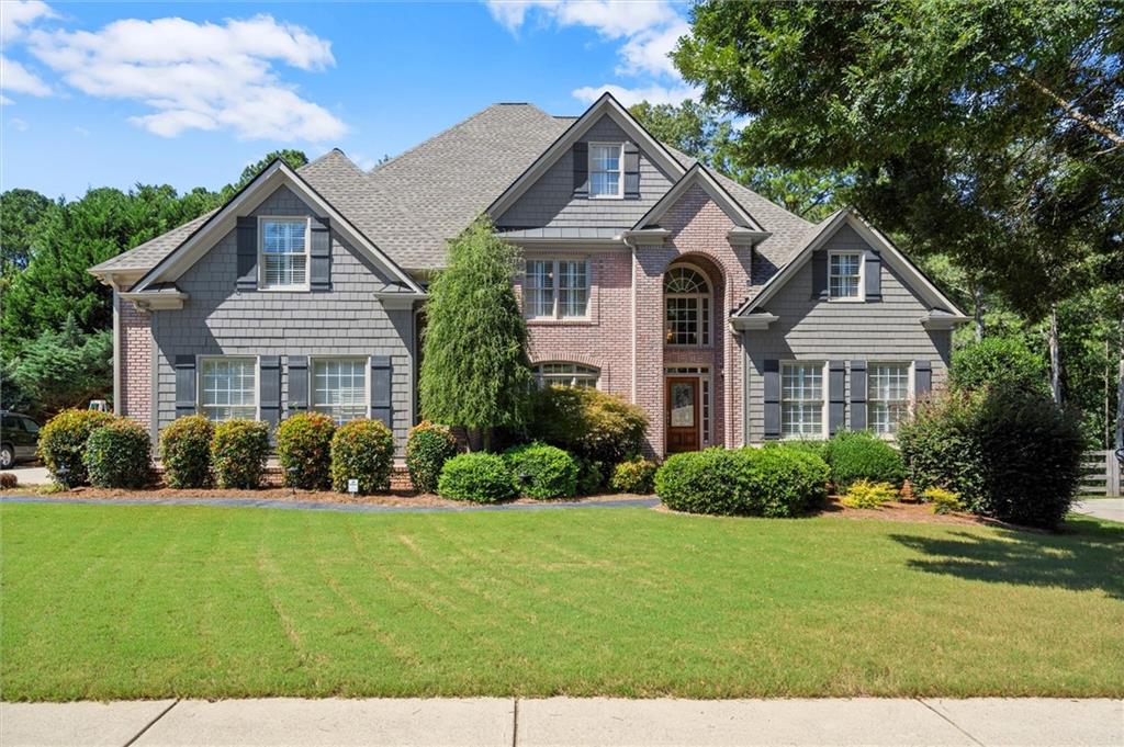 Welcome to this stunning 7-bedroom, 5.5-bathroom home boasting 6,401 sq ft of beautifully renovated living space in an exclusive golf community. Freshly painted throughout with refinished hardwood floors on the main and brand-new carpet upstairs, this home blends comfort and elegance. The updated kitchen features high-end appliances, while the renovated primary suite offers a spa-like bath and a custom closet. Secondary baths have been tastefully updated as well.The entertainer’s basement includes a large bar, media room, workout space, and doggy door. Outdoors, enjoy a newly designed deck, a large gunite pool, hot tub, stacked stone fireplace, and turf lawn within a private fenced backyard. Additional highlights include a brand-new roof and a three-car garage with epoxy-sealed flooring. Living in Bridgemill means access to incredible amenities: an 18-hole championship golf course, 2-acre aquatic center with pools and splash pad, 25 lighted tennis courts, pickleball, fitness center, parks, playgrounds, and walking trails. Plus, enjoy the vibrant community with social events, dining, and activities for all ages.This home is truly move-in ready and designed for luxury living.