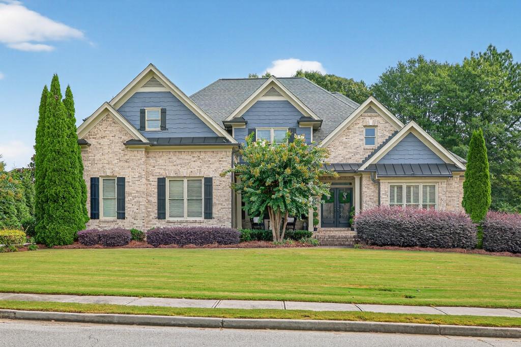 This elegant two-story brick home offers timeless curb appeal and a spacious floor plan designed for both everyday living and entertaining. Featuring 4 bedrooms , 3.5 baths and a bonus room , this property blends comfort, style, and functionality. The main level showcases beautiful hardwood floors throughout the primary living areas, including a formal dining room, a welcoming great room, and a cozy keeping room just off the kitchen. The chef's kitchen is highlighted by custom cabinetry, abundant storage, and seamless flow into the living spaces making it perfect for hosting gatherings. The luxurious primary suite offers a true retreat with a private sitting area, an expansive walk-in closet, and a spa-inspired bath complete with a large tiled shower. Additional bedrooms are generously sized, each with access to private baths, offering plenty of space and privacy for family or guests. The full unfinished basement provides endless possibilities-whether you envision a home gym, media room, or additional living space. Step outside to a spacious back deck overlooking the private backyard, ideal for entertaining, grilling, or simply relaxing. Located in one of the area's most desirable developments, this home combines luxury, location, and potential!