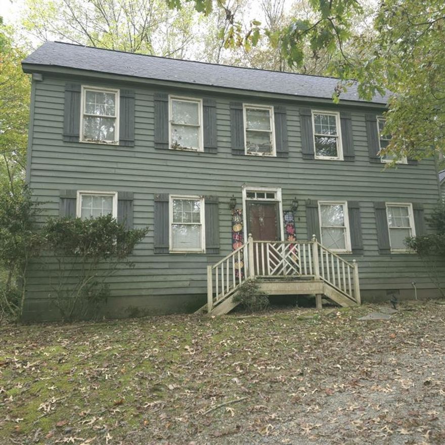 Don't wait on this one, we have already received an offer on day 1 of being active!  Spacious Colonial-Style Home with Endless Potential Nestled just 5 miles from Ellijay, this inviting two-story home offers incredible opportunity and flexibility. Surrounded by nature in a peaceful setting, it's the perfect second home or rental getaway to escape everyday life. From the side entrance, you'll find a full bathroom with a stand-up shower conveniently located across from the laundry room-which also offers space to add a sink or convert into a mudroom. The kitchen provides everything you need for comfortable everyday living, featuring a pantry with pegboard storage for pots and pans, tile countertops, a built-in microwave, white appliances, and a garbage disposal, and a stylish mix of light upper cabinets some with glass fronts and dark lower cabinets for contrast. The layout includes space for a small table. From the kitchen, you can enter the den or access the spacious dining room through a separate doorway. The den features a door leading to the back deck for easy indoor-outdoor flow and includes a walk-in closet, making it suitable as a fourth bedroom if desired. Just beyond, the parlor area adds character and versatility, connecting seamlessly to the den and foyer-perfect for entertaining or creating a cozy reading nook. The dining room is impressive, approximately 400 square feet (20x20), with two walk-in closets for ample storage. The current owner envisioned transforming this space into a primary suite, converting the nearby laundry into a private en suite bath and repurposing the existing full bath across the hall into a new laundry area. Upstairs, you'll find three bedrooms and two full bathrooms. The primary suite features a spacious bedroom and large soaking tub, creating a relaxing retreat. The attic, accessed by disappearing stairs, includes an area with plywood flooring for additional storage. Additional highlights include a new roof, heating and air system, a carriage-style two-car garage with a breezeway, and a space above the garage that could easily be turned into a loft area. Heating ducts can also be extended from the main house for climate control. The property operates on well water and a septic system and sits on a desirable corner lot where the private road meets the main road-offering both privacy and convenience. Located in a resort-style area ideal for a second home, rental, or wooded retreat, this property provides space, flexibility, and the potential to make it your dream getaway.